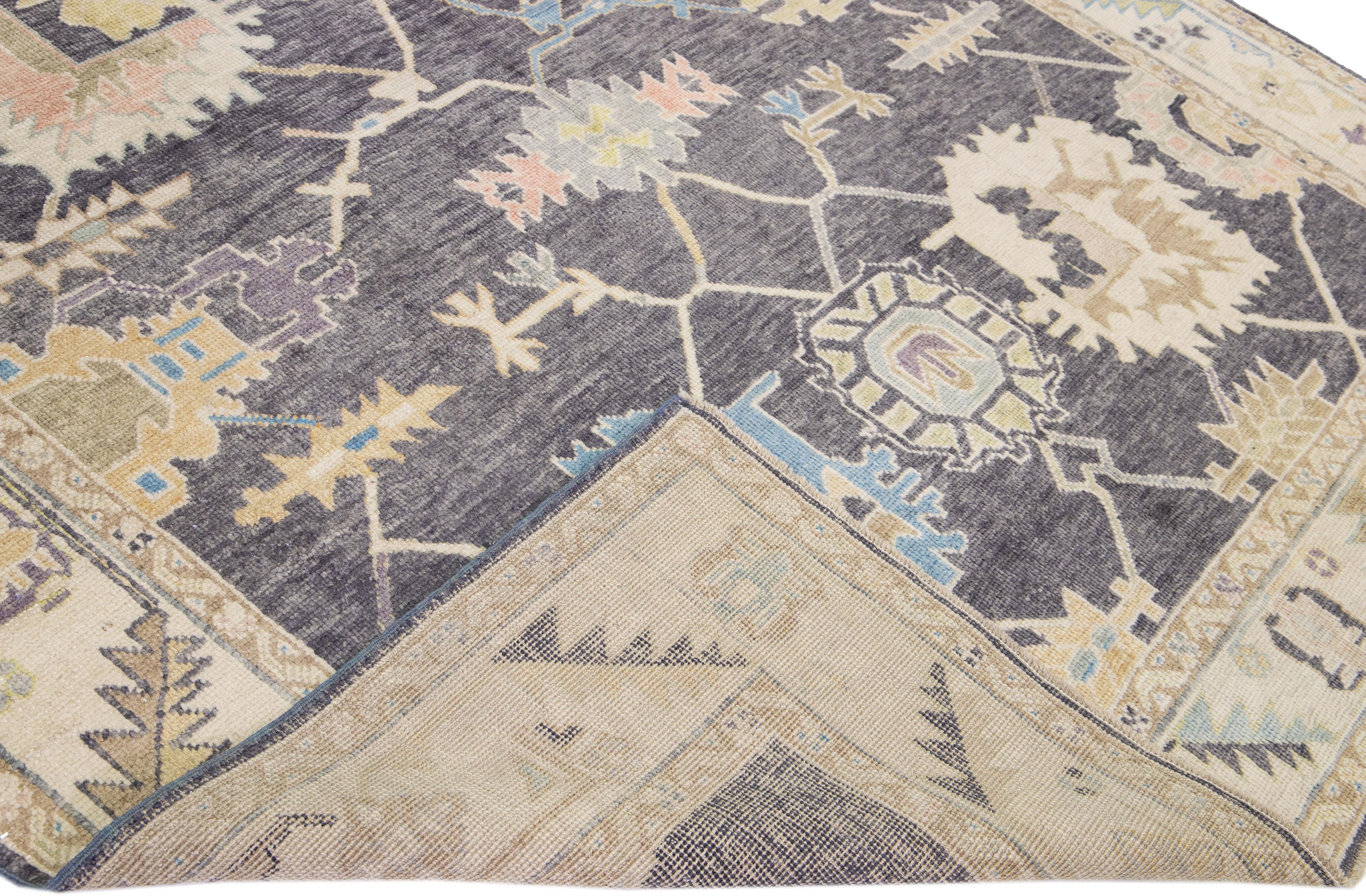 Beautiful modern Oushak hand-knotted wool rug with a gray field. This Turkish rug has a beige frame and multicolor accents in a gorgeous all-over floral design.

This rug measures: 8'2