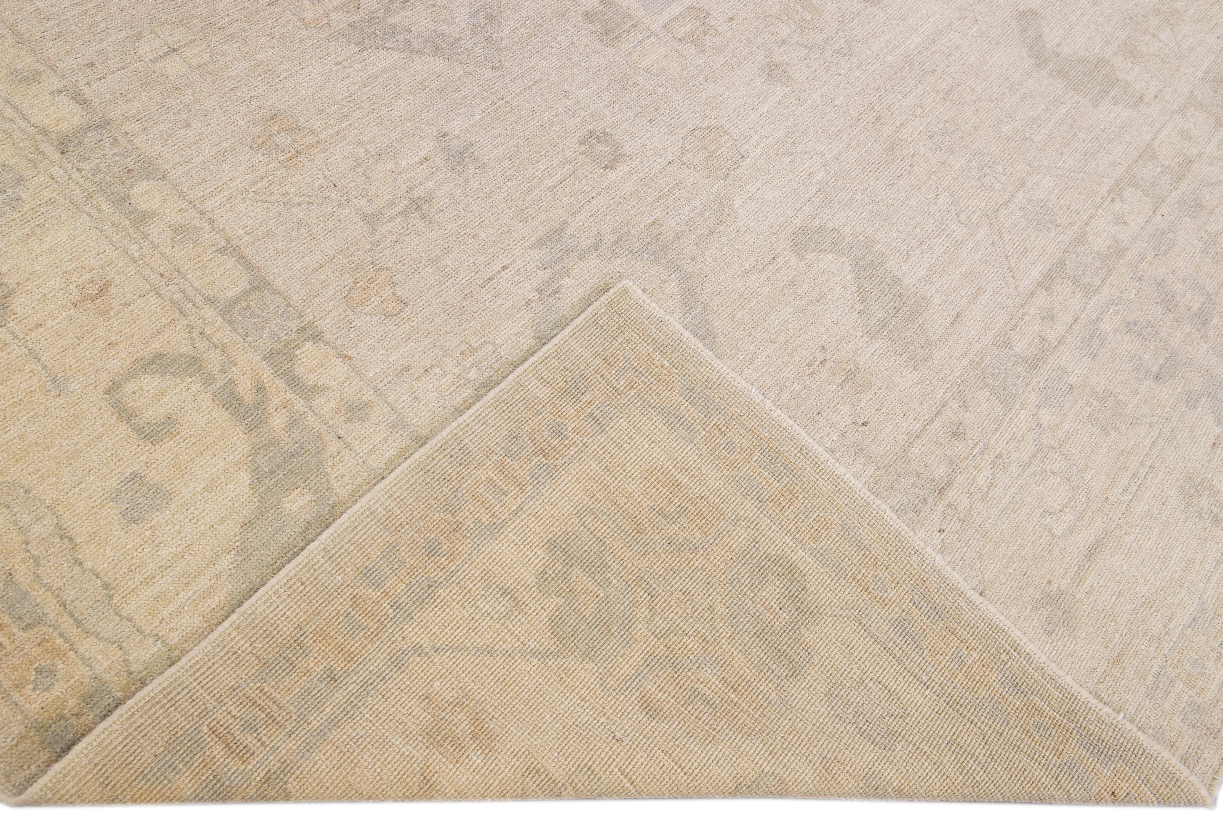 Beautiful contemporary Turkish Oushak hand-knotted rug with the beige field. This Oushak has gray accents in an all-over floral design. 

This rug measures 9'4