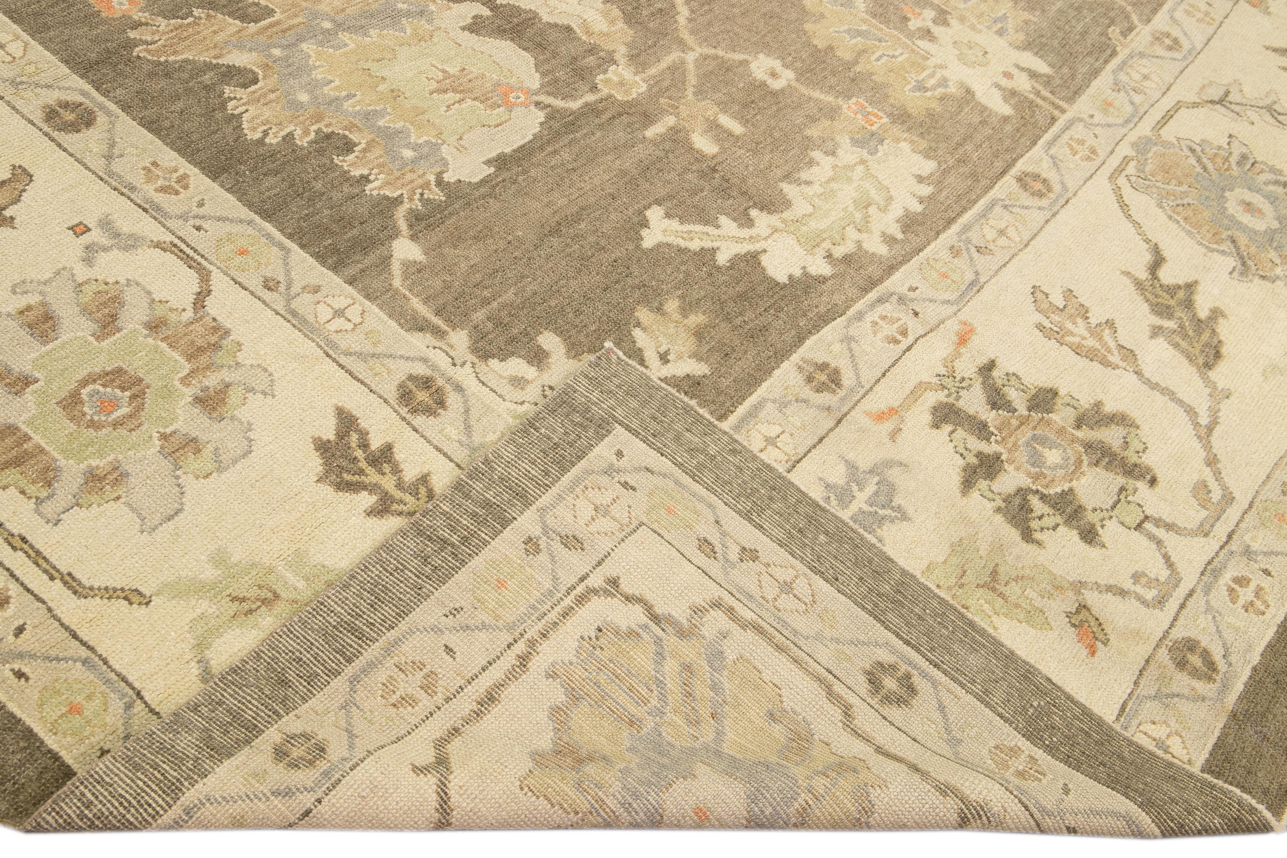 Beautiful modern Oushak hand-knotted wool rug with a brown field. This Oushak rug has multicolor accents all over a gorgeous floral motif.

This rug measures 12'10