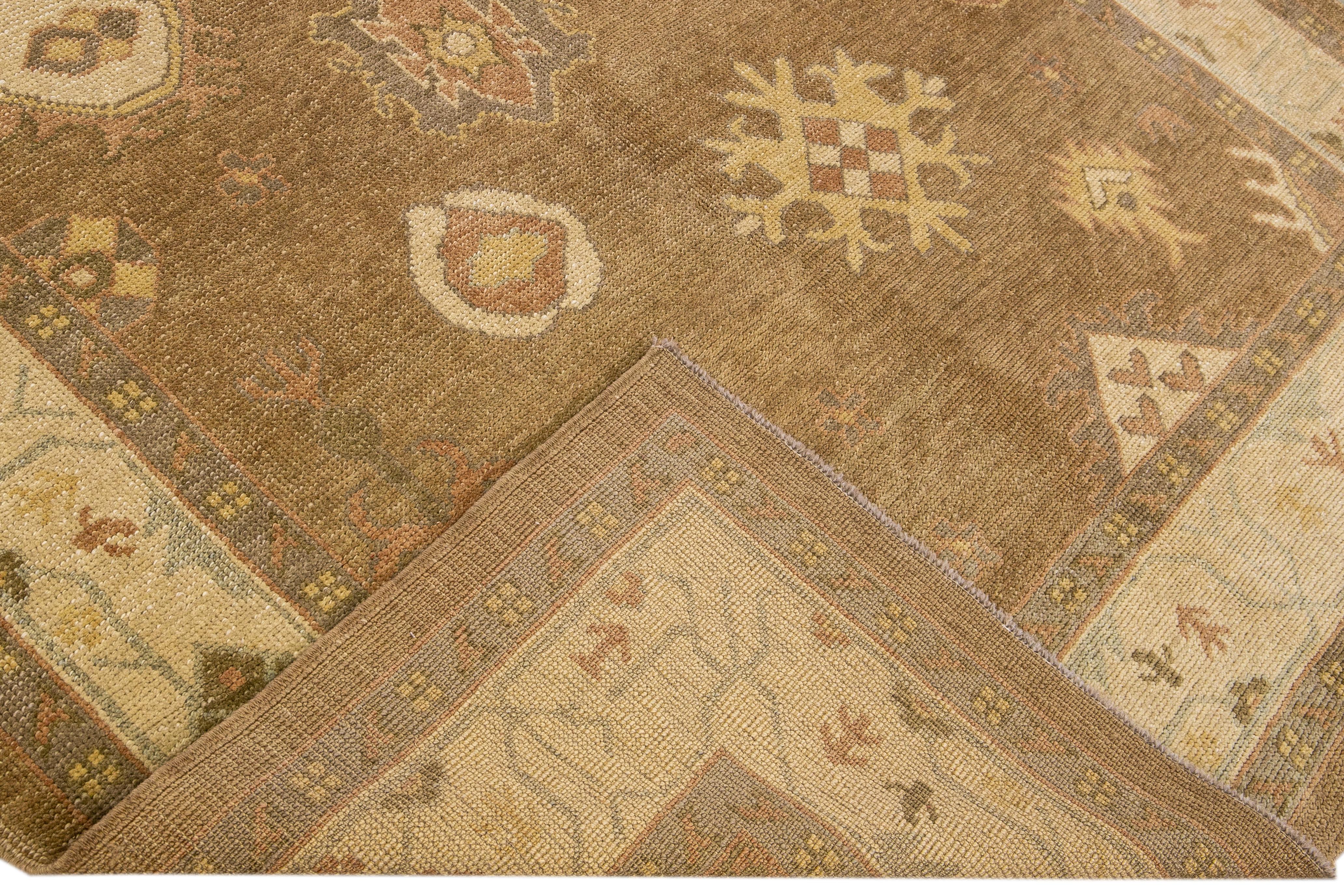 Beautiful Turkish Oushak hand-knotted wool rug with the tan field. This Turkish rug has a beige frame and multicolor accents in a gorgeous layout floral motif.

This rug measures: 6'5