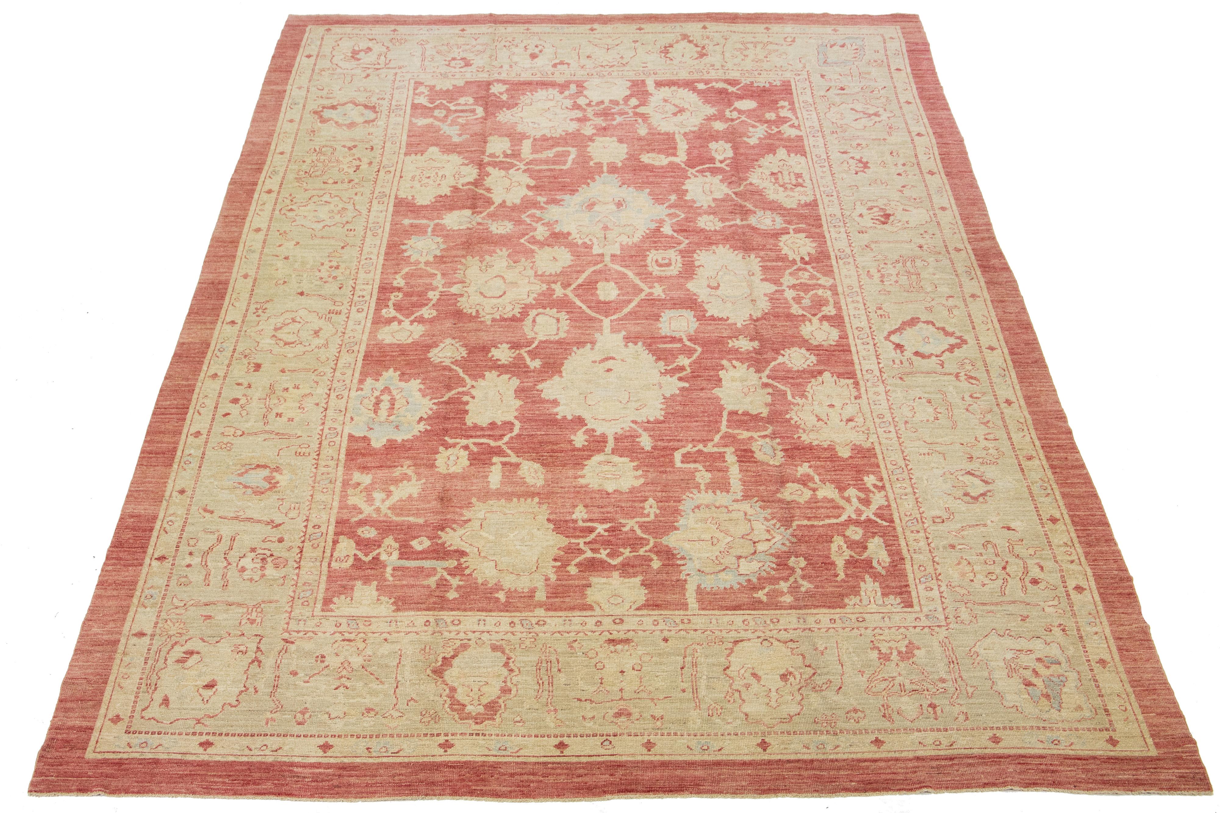 Beautiful Modern Turkish hand-knotted wool rug with a red field. This rug has a designed blue frame with multicolor accents in a gorgeous large-scale floral pattern.

This rug measures: 11'9