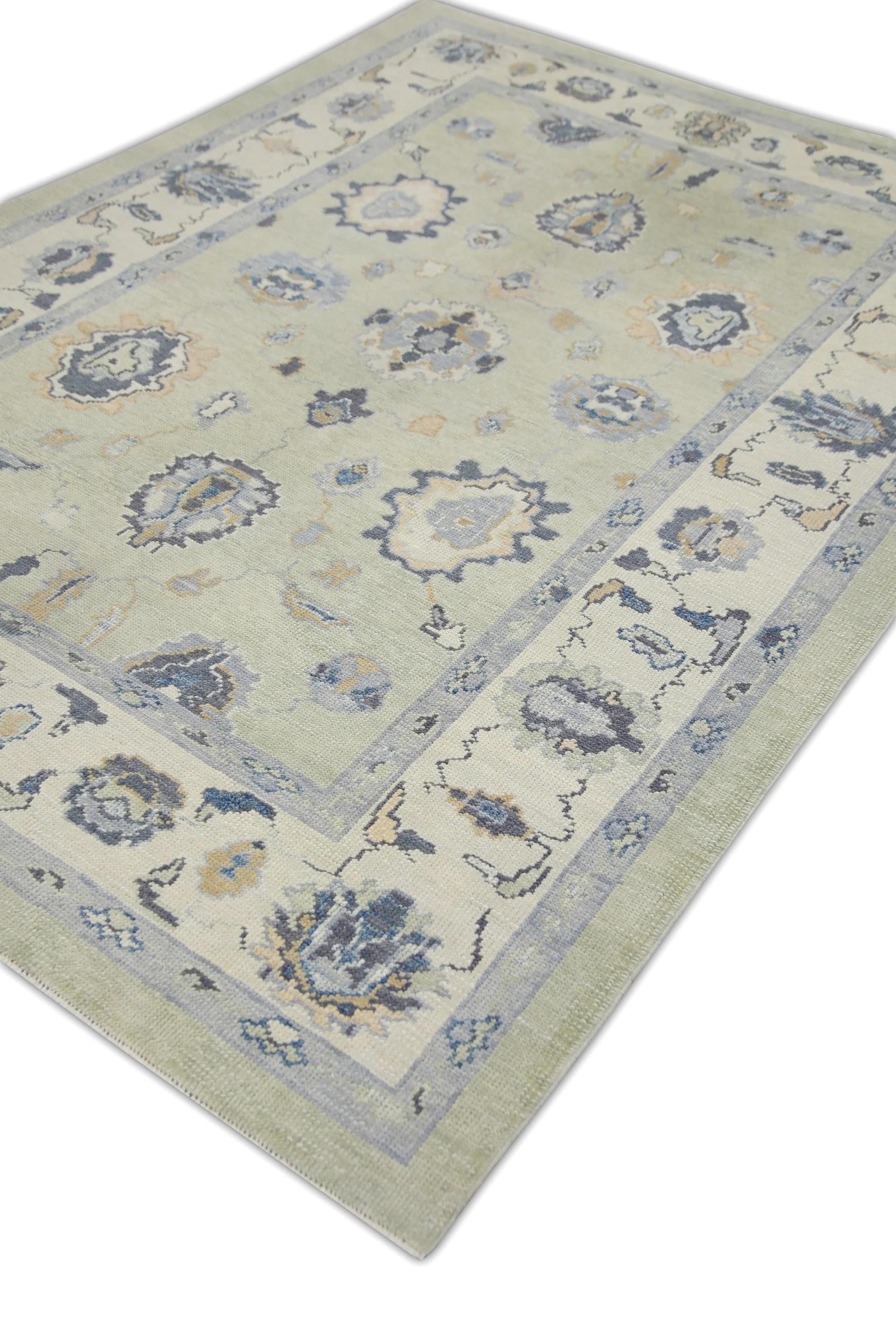 This modern Turkish oushak rug is a stunning piece of art that has been handwoven using traditional techniques by skilled artisans. The rug features intricate patterns and a soft color palette that is achieved through the use of natural vegetable