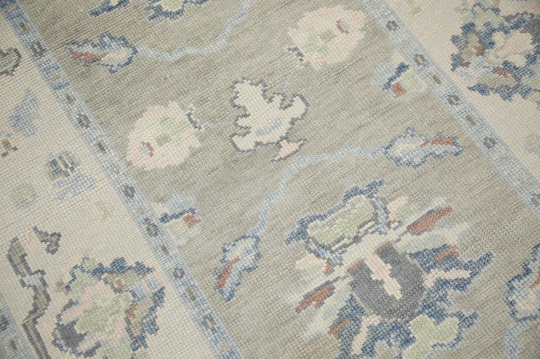This modern Turkish oushak rug is a stunning piece of art that has been handwoven using traditional techniques by skilled artisans. The rug features intricate patterns and a soft color palette that is achieved through the use of natural vegetable