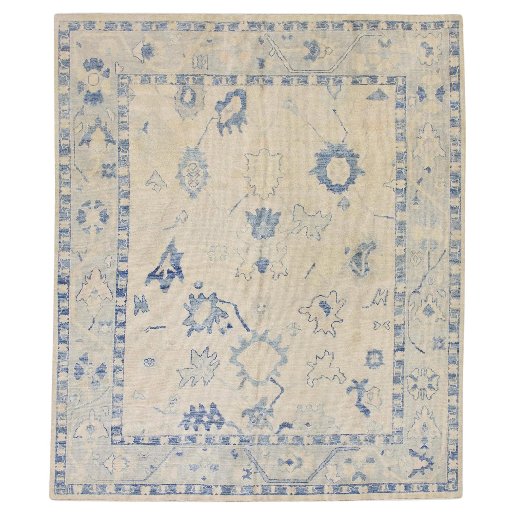 Cream Handwoven Wool Turkish Oushak Rug in Blue Floral Design 8' x 9'5" For Sale