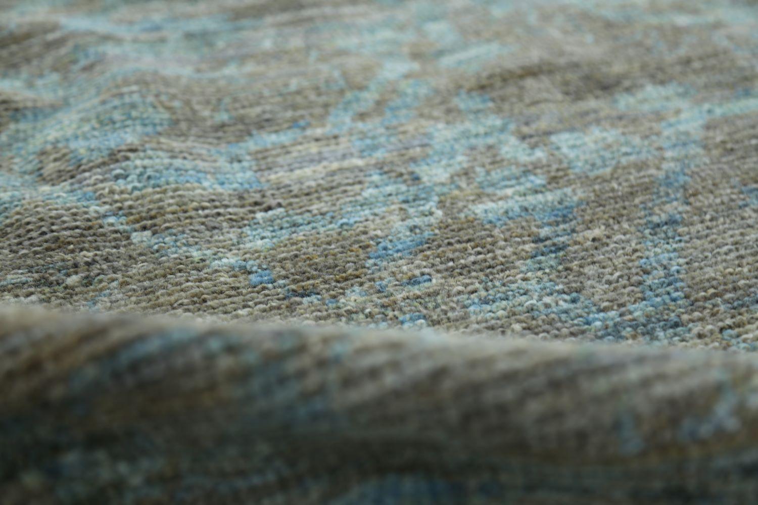 The colors of this modern Oushak carpet are earthy and bring a bit of the natural world indoors. Blue and brown are a reflection of earthy and sky, or perhaps earth and water. The colors of this carpet are rich and intense, and the pattern is