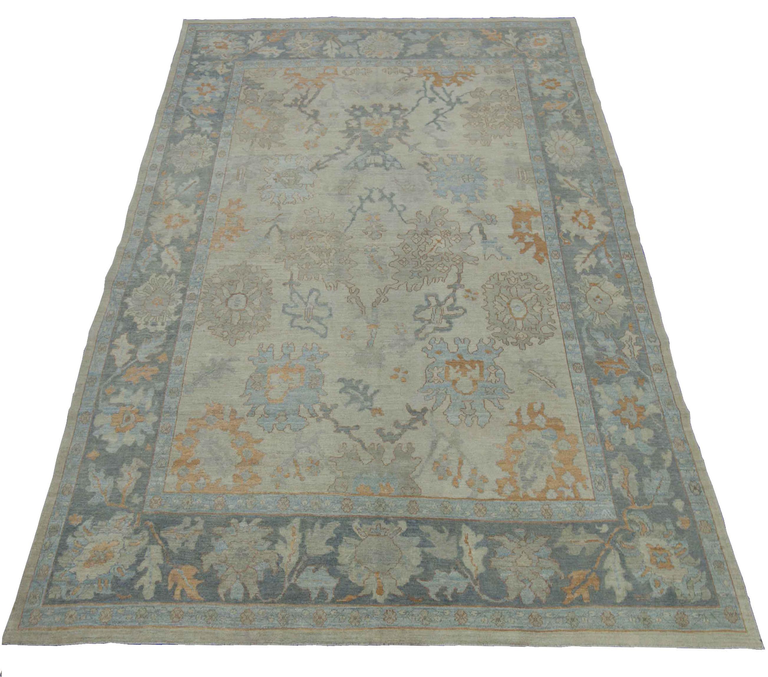 Modern Turkish rug made of handwoven sheep’s wool of the finest quality. It’s colored with organic vegetable dyes that are certified safe for humans and pets alike. It features a beige field and blue border with amazing floral patterns identified