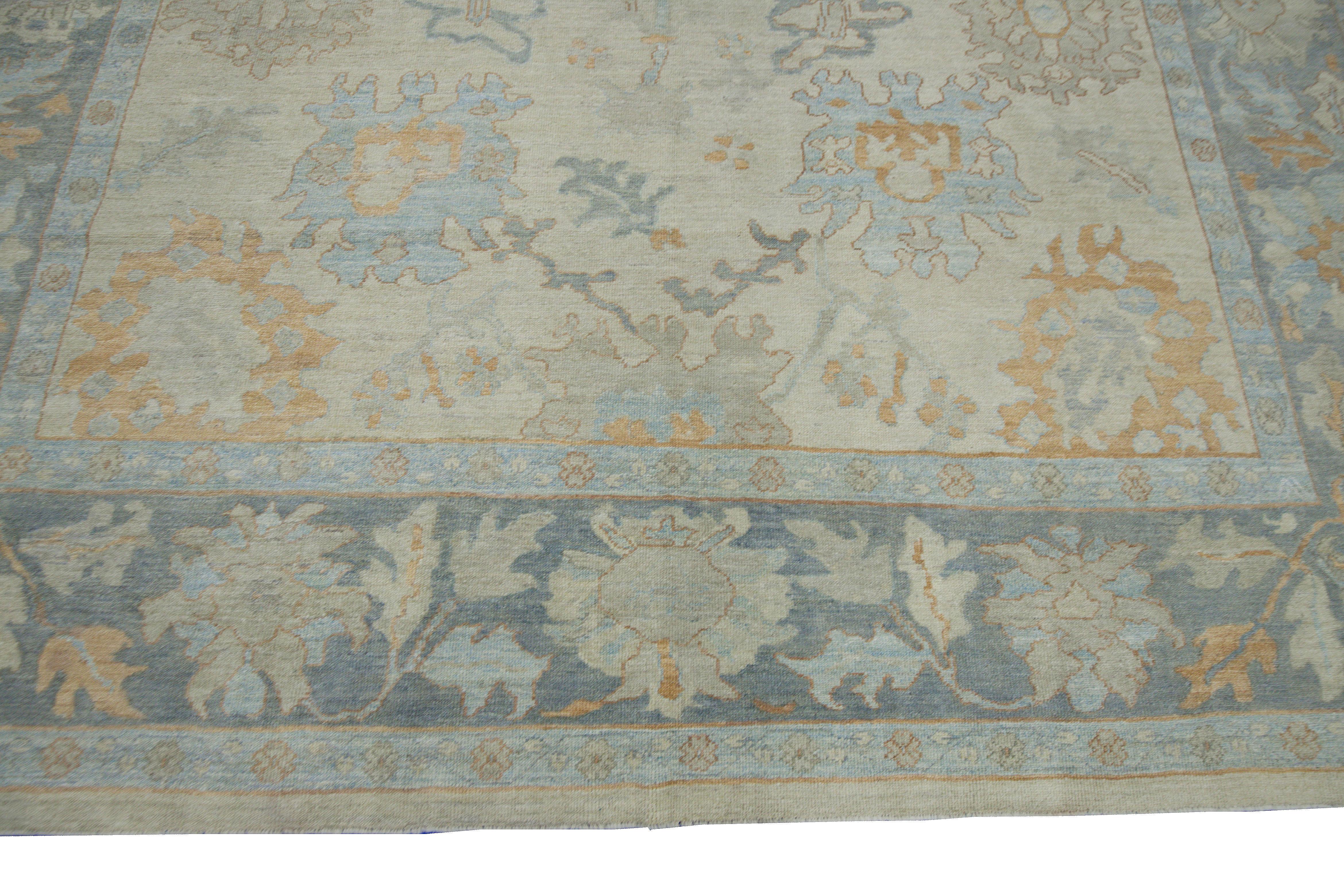 Hand-Woven Modern Turkish Oushak Rug with Beige Field and Blue Border with Floral Details For Sale