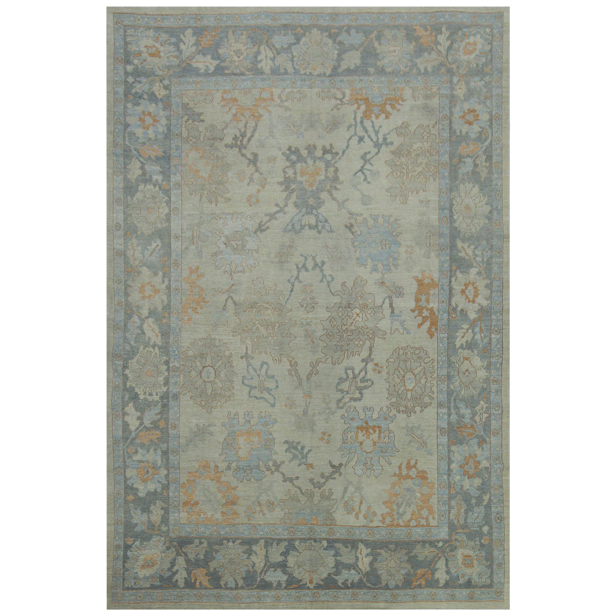 Modern Turkish Oushak Rug with Beige Field and Blue Border with Floral Details For Sale