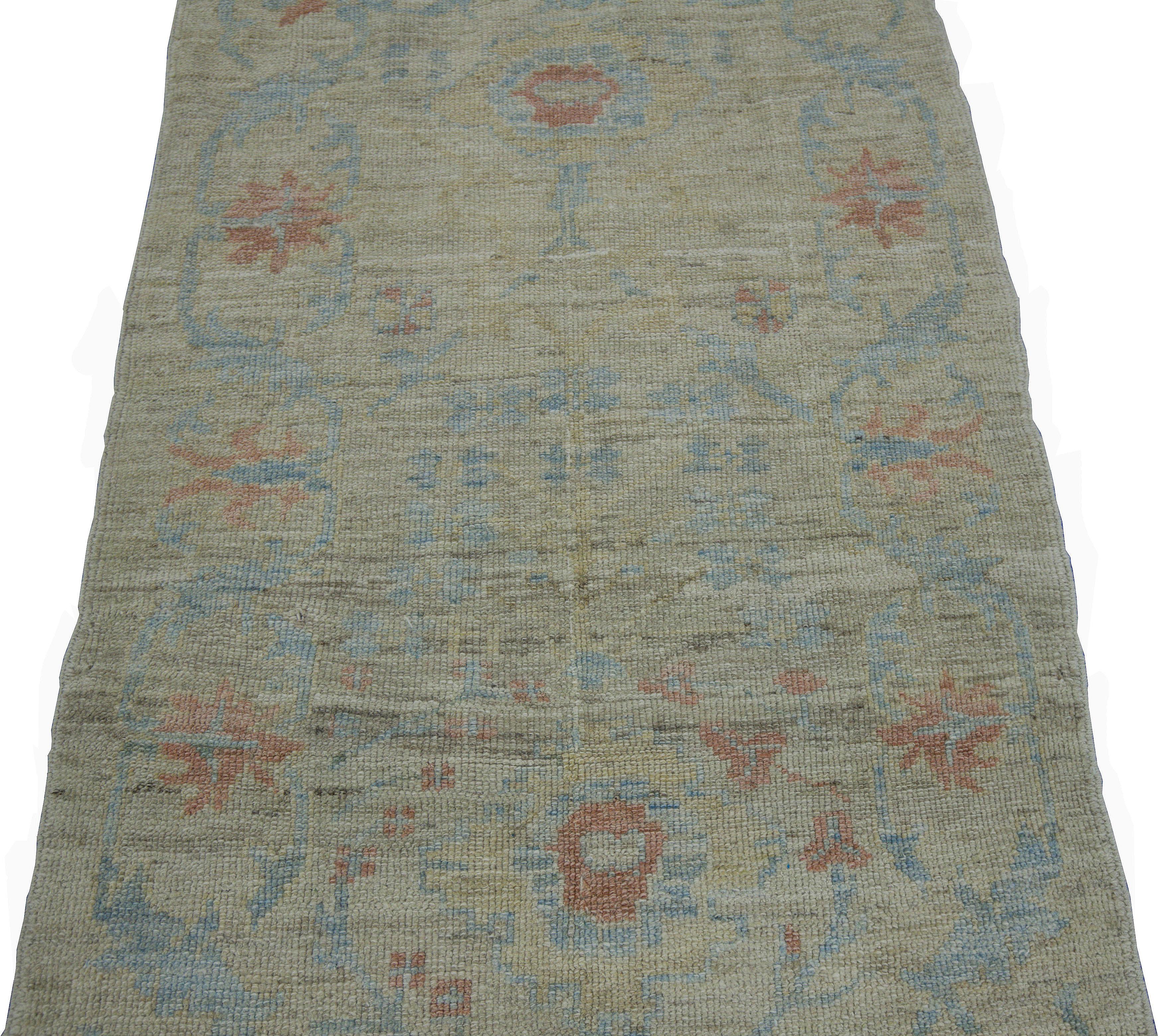Modern Turkish rug made of handwoven sheep’s wool of the finest quality. It’s colored with organic vegetable dyes that are certified safe for humans and pets alike. It features a beige field with no border but covered in amazing blue and red floral
