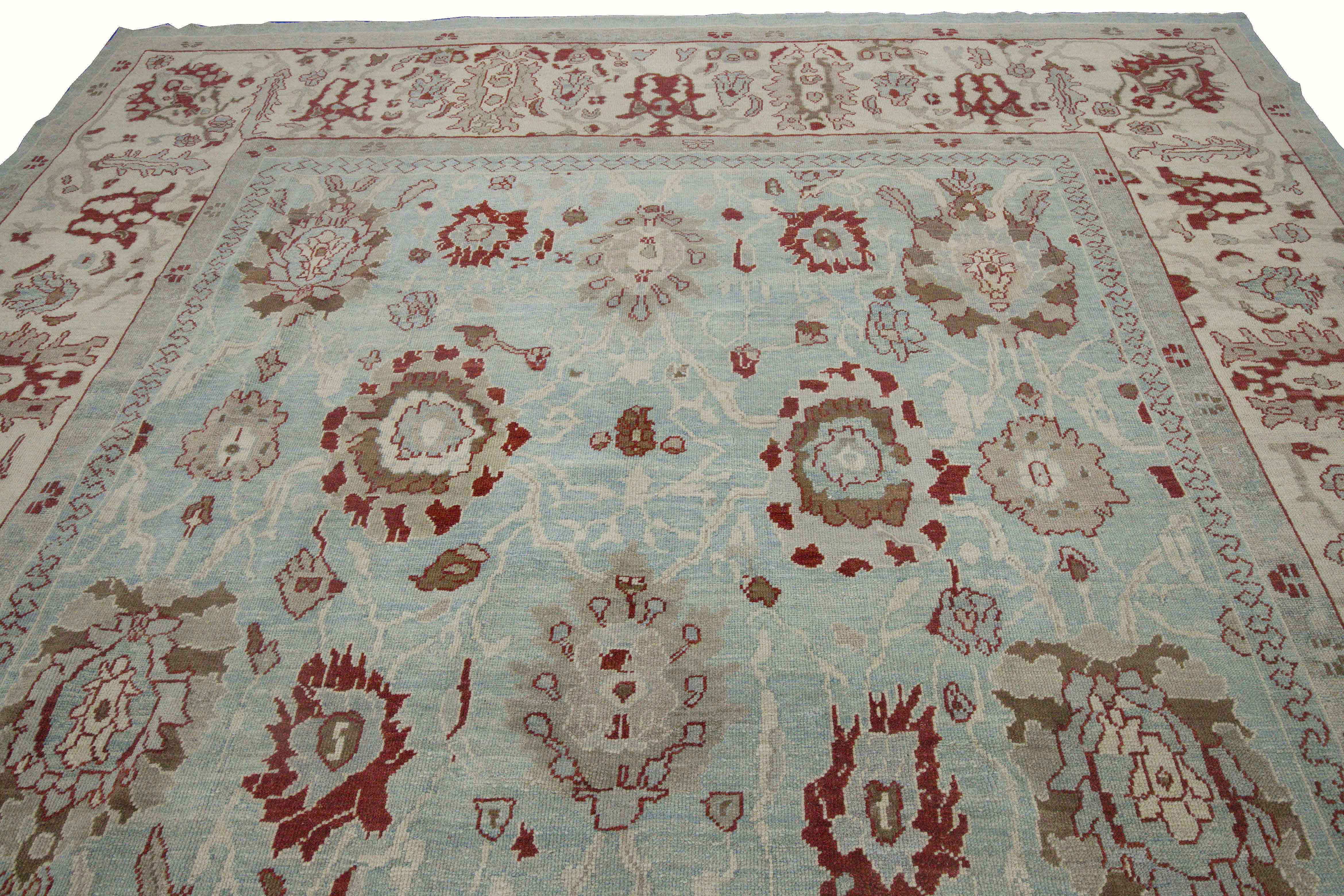 Modern Turkish rug made of handwoven sheep’s wool of the finest quality. It’s colored with organic vegetable dyes that are certified safe for humans and pets alike. It features a combination blue and ivory field with unique flower head details in