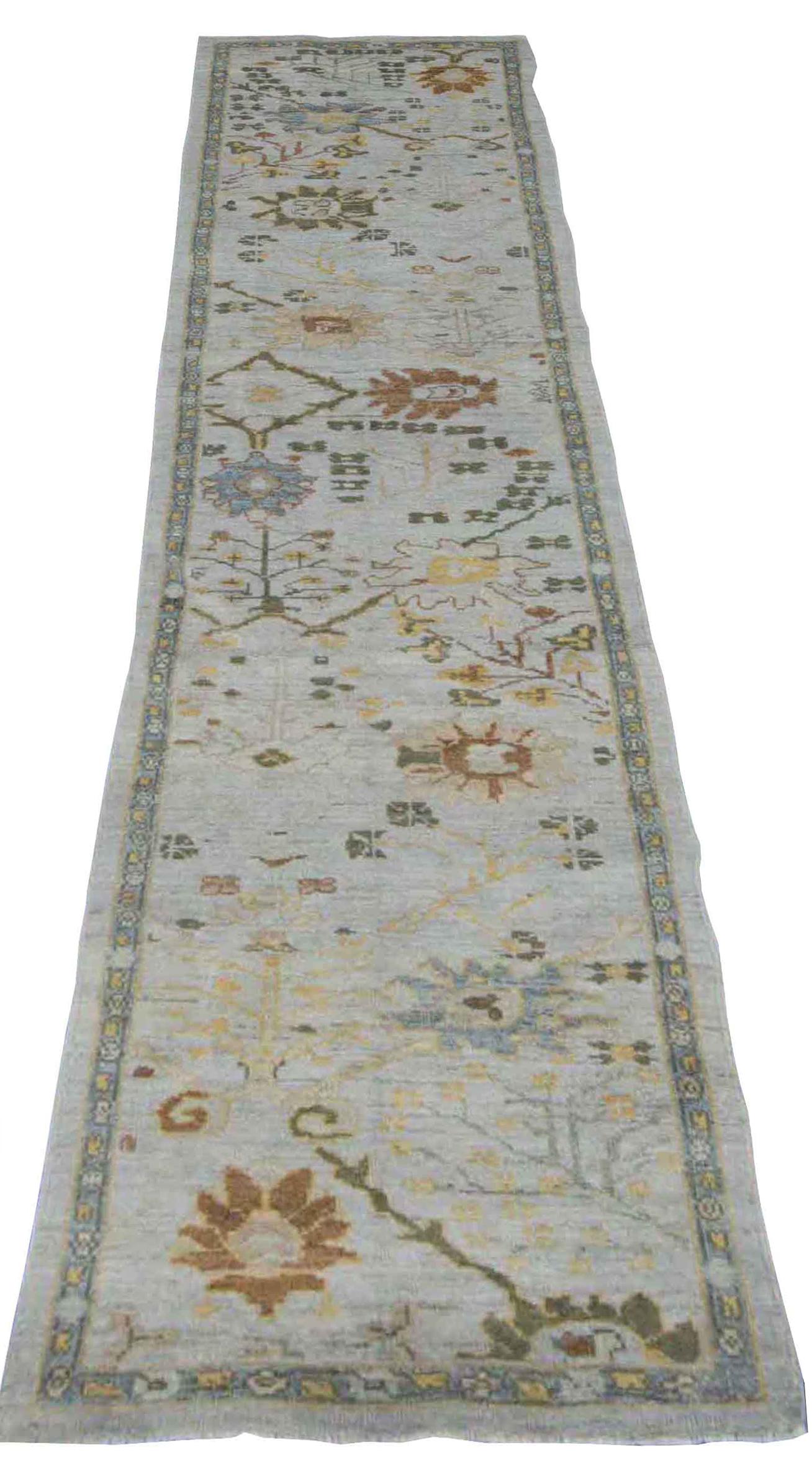 Modern Turkish rug made of handwoven sheep’s wool of the finest quality. It’s colored with organic vegetable dyes that are certified safe for humans and pets alike. It features an ivory field with brown floral patterns identified with Oushak weaving