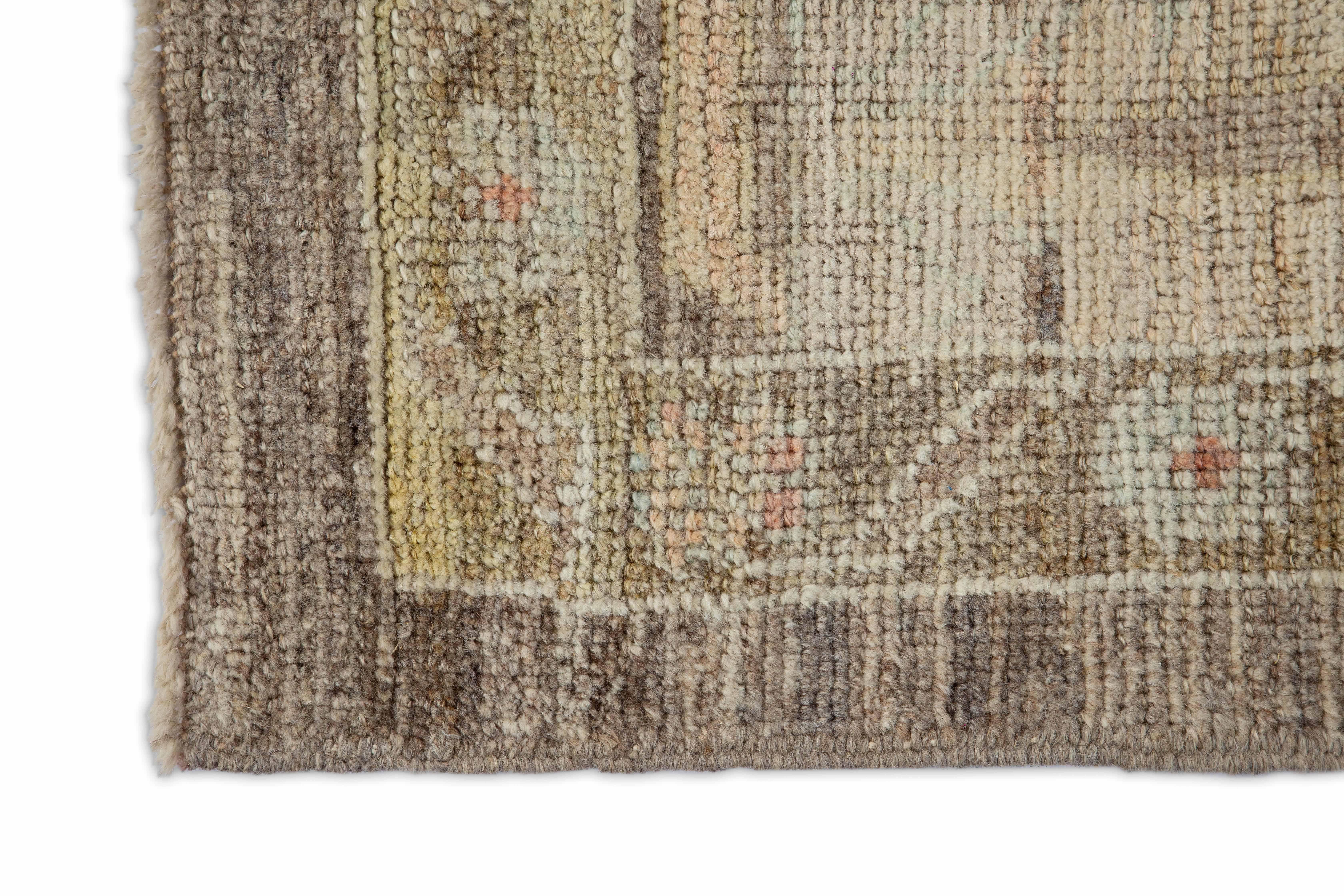 Modern Turkish area rug made of handwoven sheep’s wool of the finest quality. It’s colored with organic vegetable dyes that are certified safe for humans and pets alike. It features a brown field with dense floral patterns in pink, beige and blue