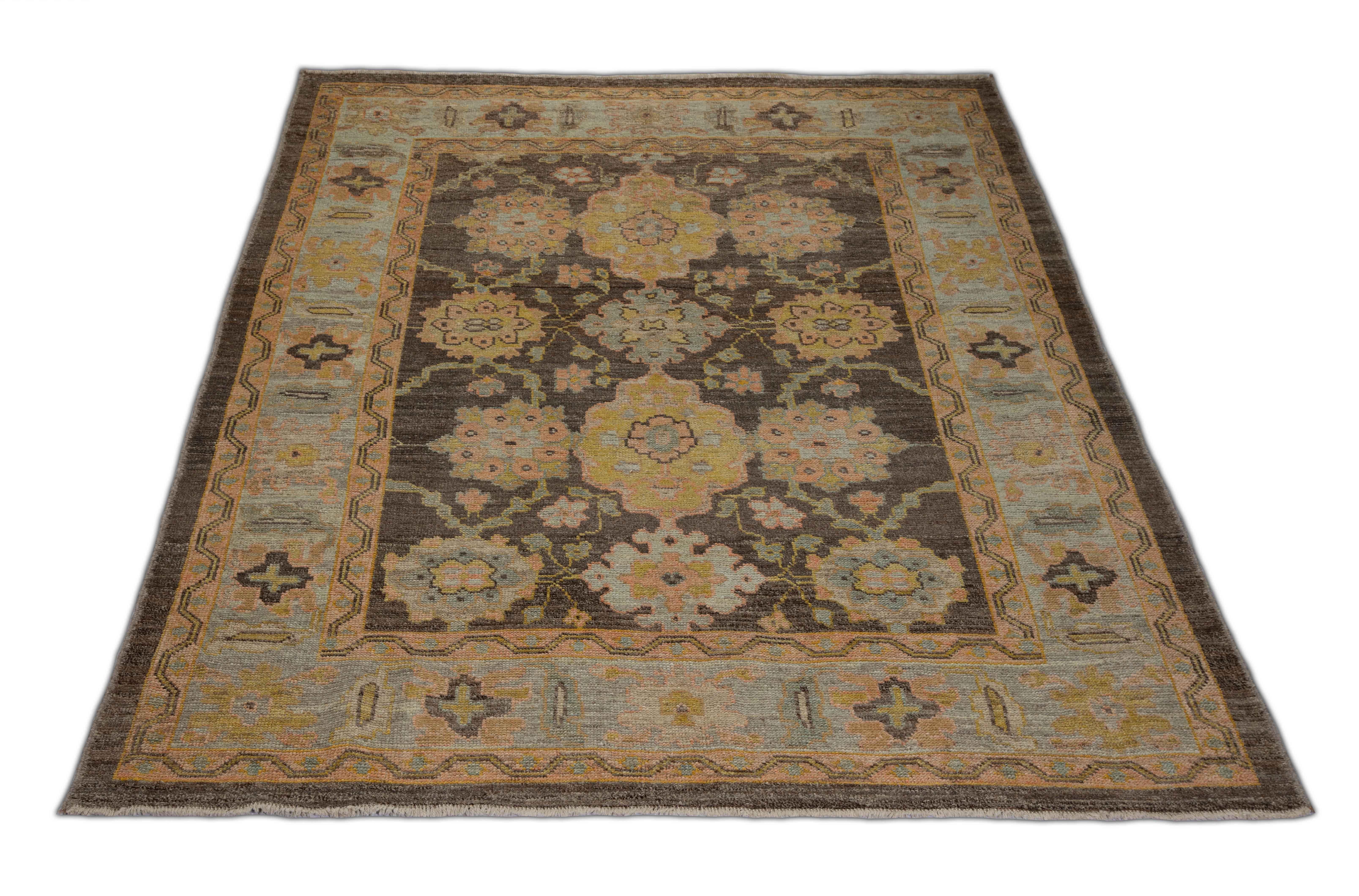 New Turkish rug made of handwoven sheep’s wool of the finest quality. It’s colored with organic vegetable dyes that are certified safe for humans and pets alike. It features a large, brown center field with flower medallions allover associated with