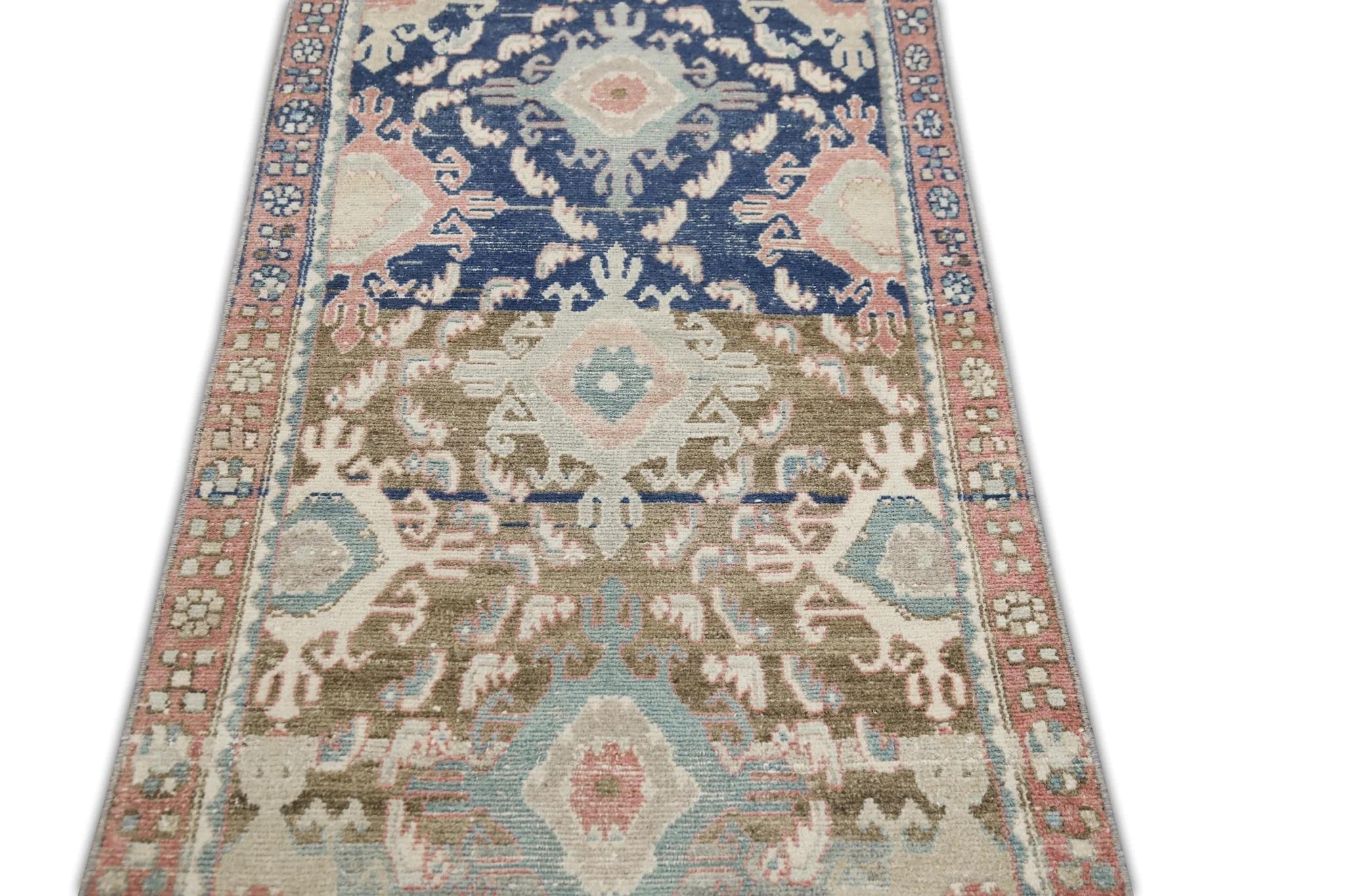 Introducing a stunning piece of history to your home décor, this vintage  hand knotted wool rug is a true masterpiece. Crafted by skilled artisans using traditional techniques, this rug features a beautiful combination of natural dyes that create a