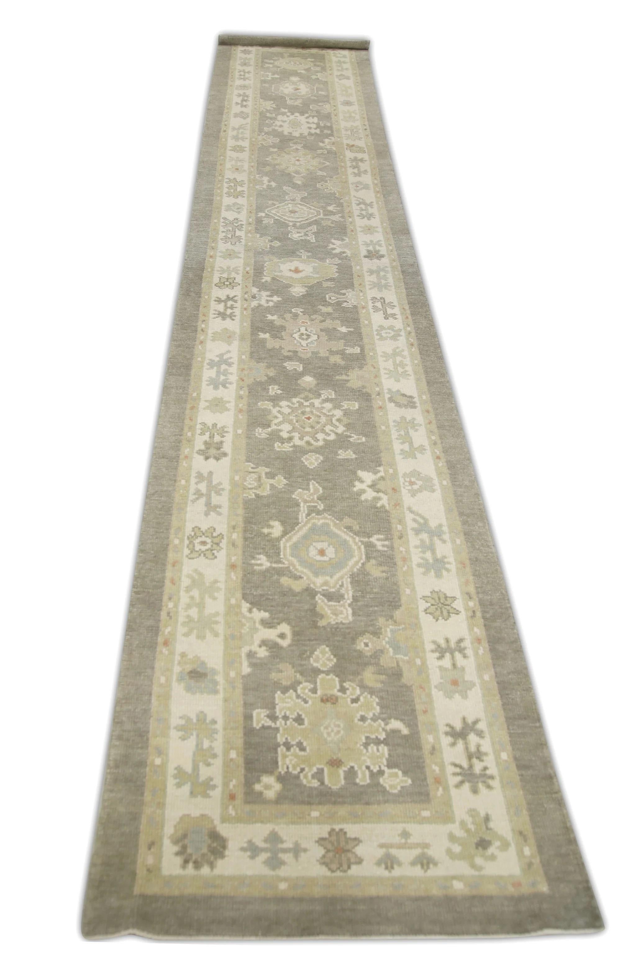 This modern Turkish oushak rug is a stunning piece of art that has been handwoven using traditional techniques by skilled artisans. The rug features intricate patterns and a soft color palette that is achieved through the use of natural vegetable