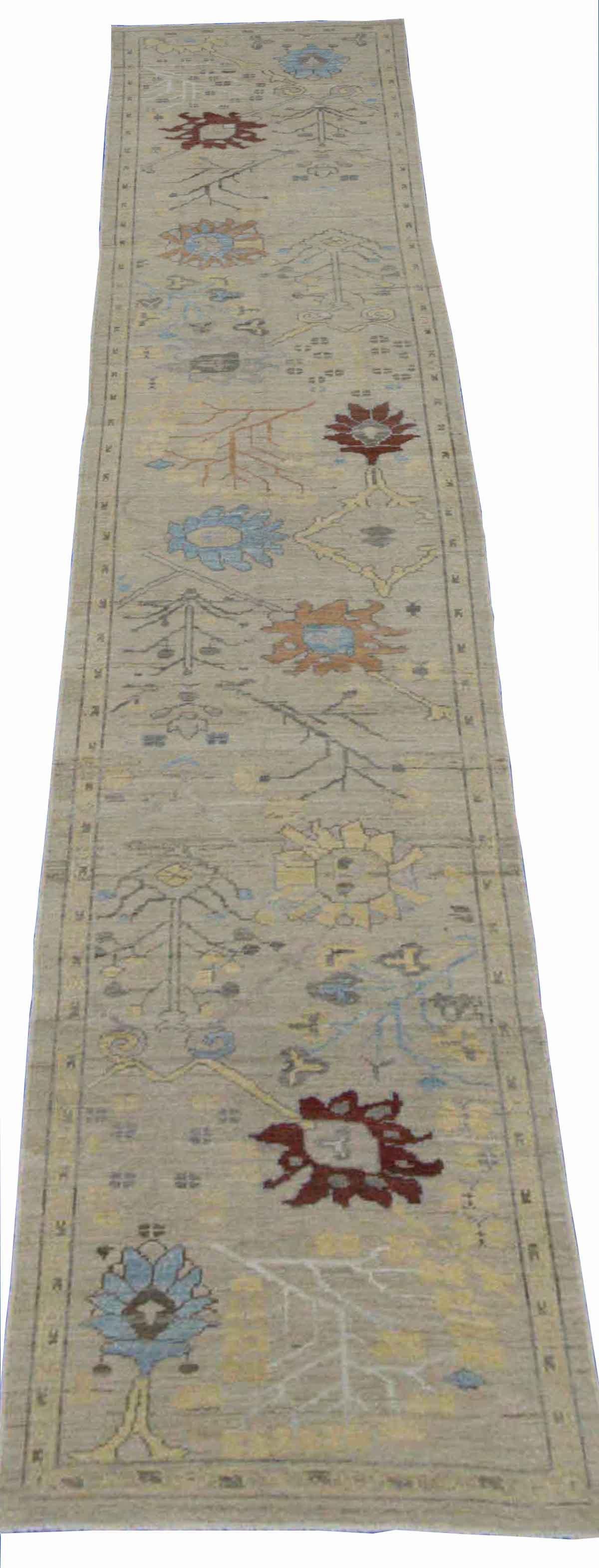 Modern Turkish runner rug made of handwoven sheep’s wool of the finest quality. It’s colored with organic vegetable dyes that are certified safe for humans and pets alike. It features an ivory field with flower details in yellow and blue associated