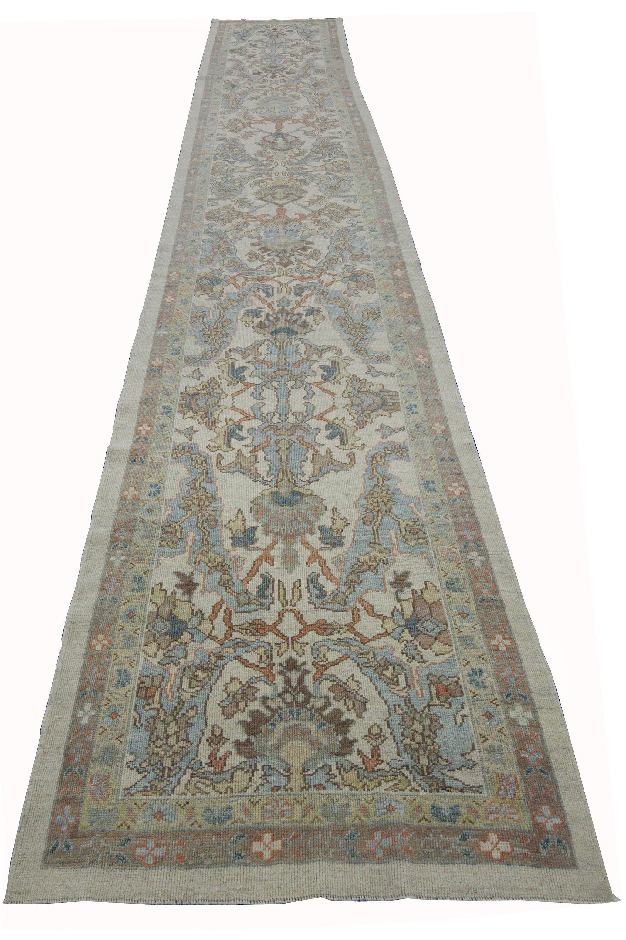 New Turkish runner rug made of handwoven sheep’s wool of the finest quality. It’s colored with organic vegetable dyes that are certified safe for humans and pets alike. It features a large, ivory field with blue flower details allover associated