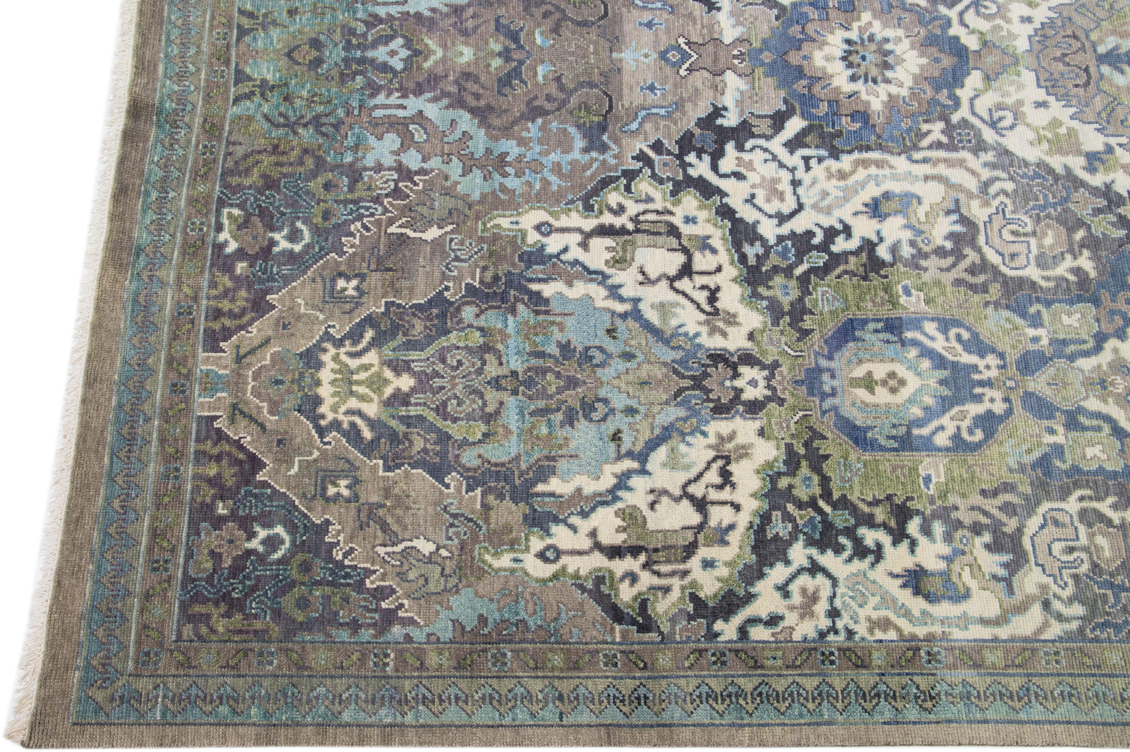 Beautiful modern Oushak hand-knotted wool rug with a gray field. This Turkish rug has a green-designed frame with blue and beige accents in a gorgeous all-over floral pattern design.

This rug measures: 9'11