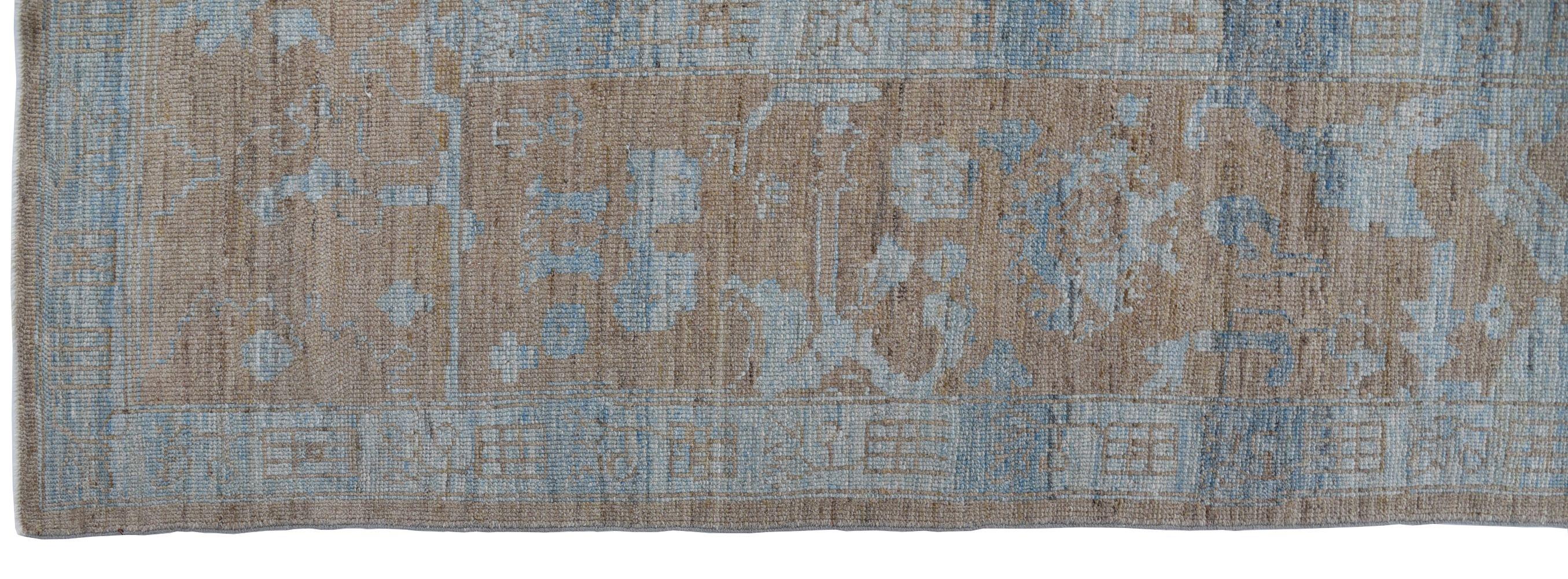 This gorgeous earthy modern Oushak rug uses neutral tones and has an abstract quality that would be perfect for a contemporary room setting. Oushak is a city in Turkey that has carpet weaving traditions that go back to the 15th and 16th centuries.