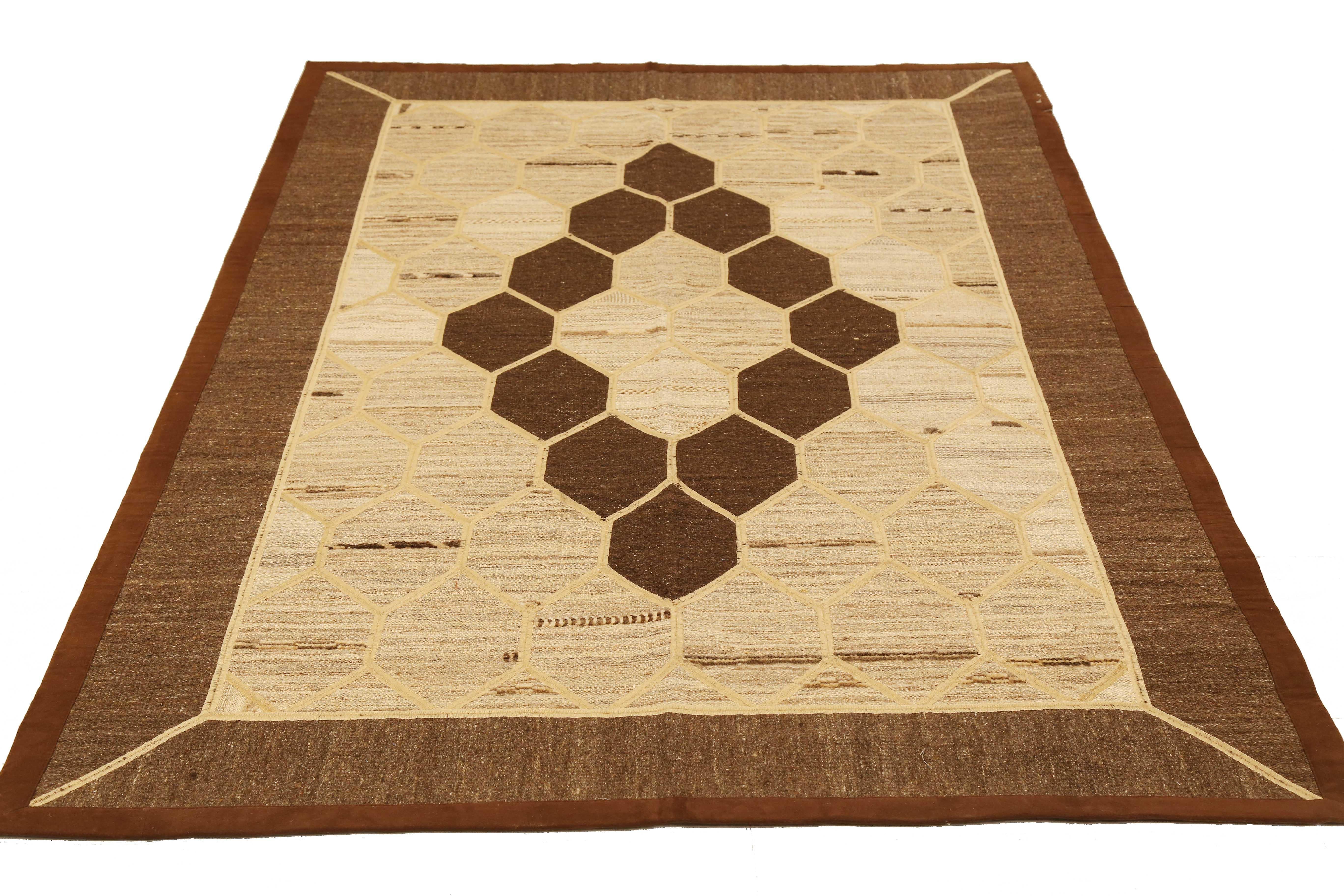 Modern Turkish rug handwoven from the finest sheep’s wool and colored with all-natural vegetable dyes that are safe for humans and pets. It’s a traditional Patch Kilim flat-weave design featuring brown and ivory beehive pattern. It’s a stunning