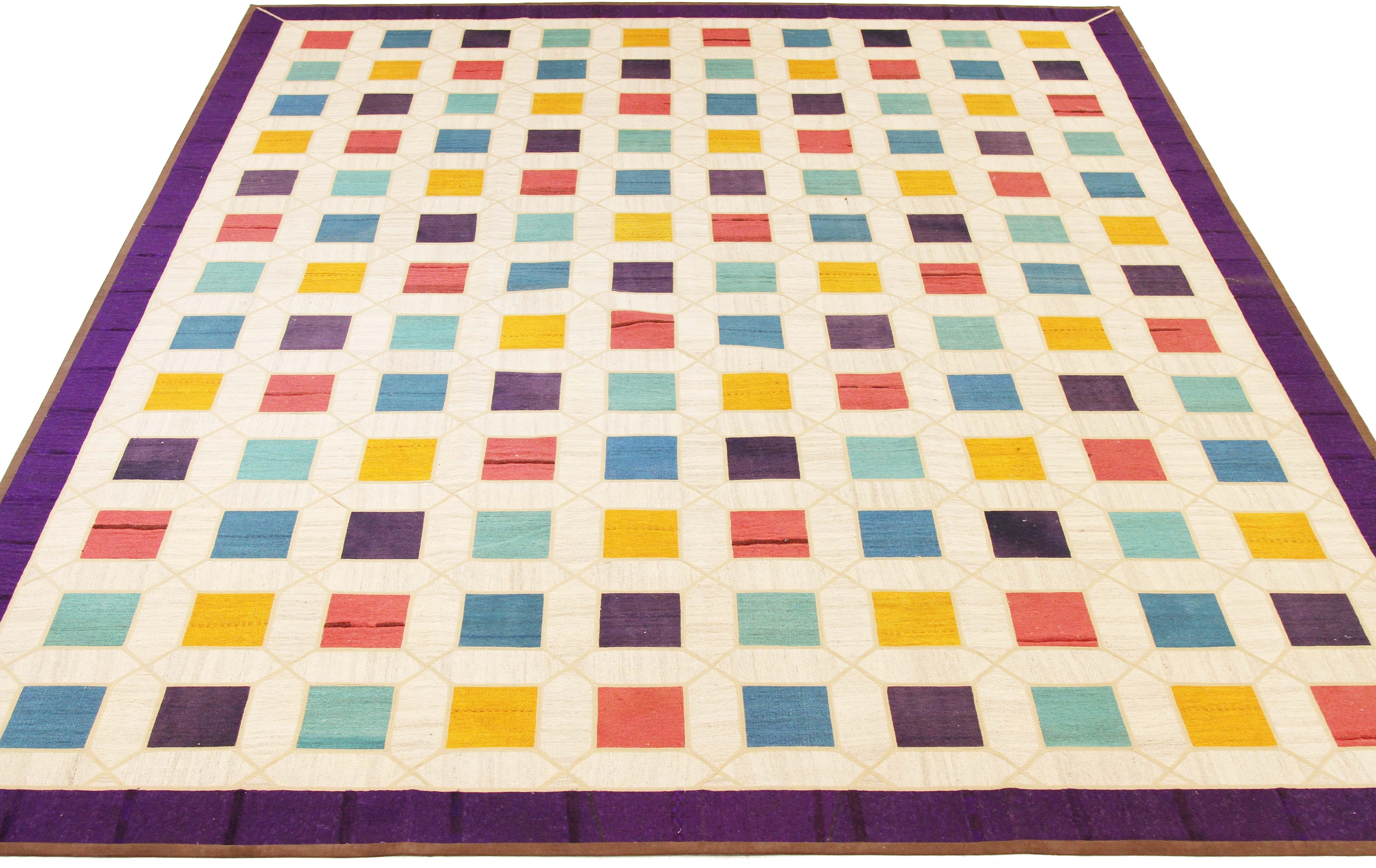 Modern Turkish rug handwoven from the finest sheep’s wool and colored with all-natural vegetable dyes that are safe for humans and pets. It’s a traditional Patch Kilim flat-weave design featuring colored squares on an ivory field. It’s a stunning
