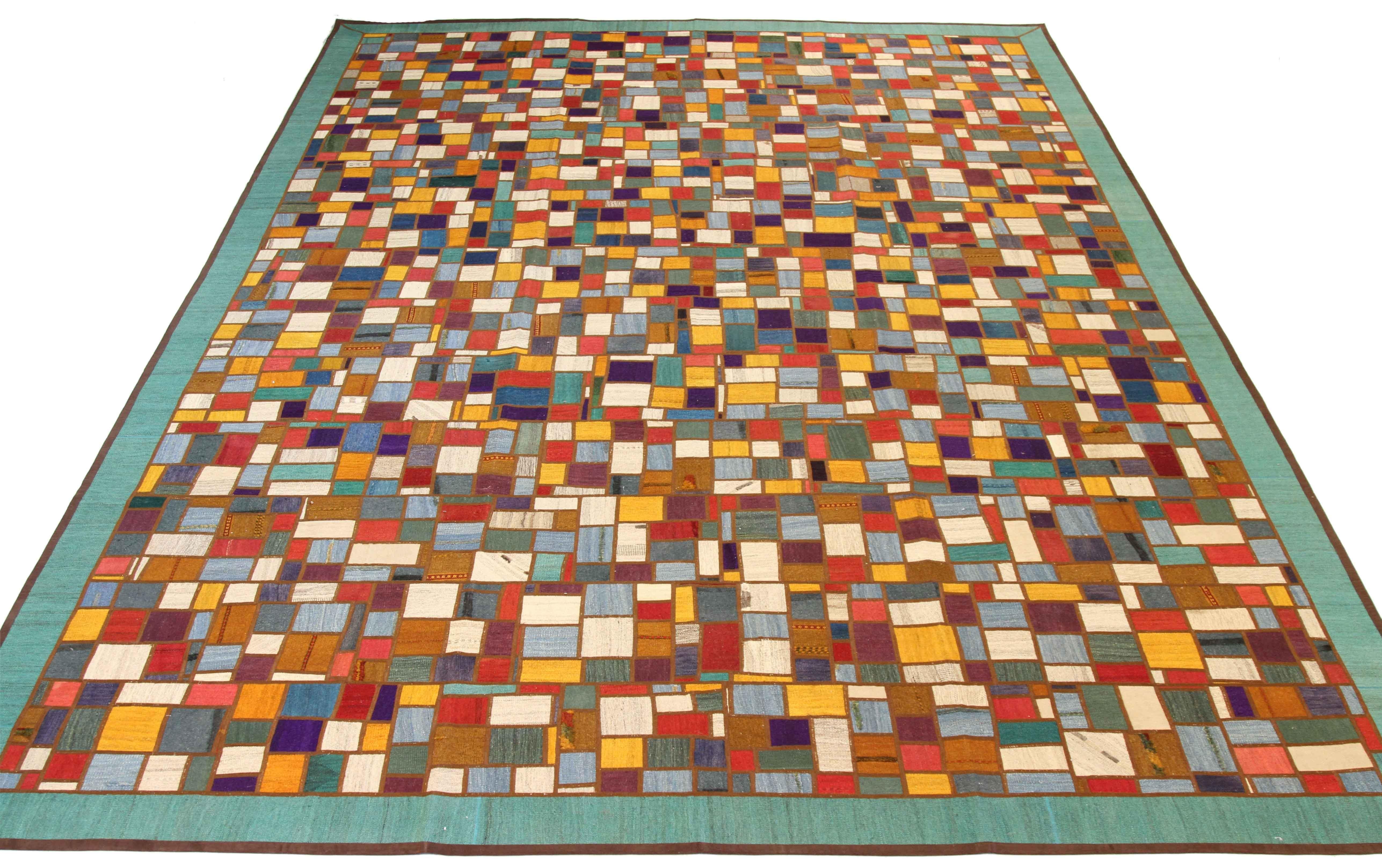 Modern Turkish rug handwoven from the finest sheep’s wool and colored with all-natural vegetable dyes that are safe for humans and pets. It’s a traditional Patch Kilim flat-weave design featuring colored squares on an ivory field. It’s a stunning