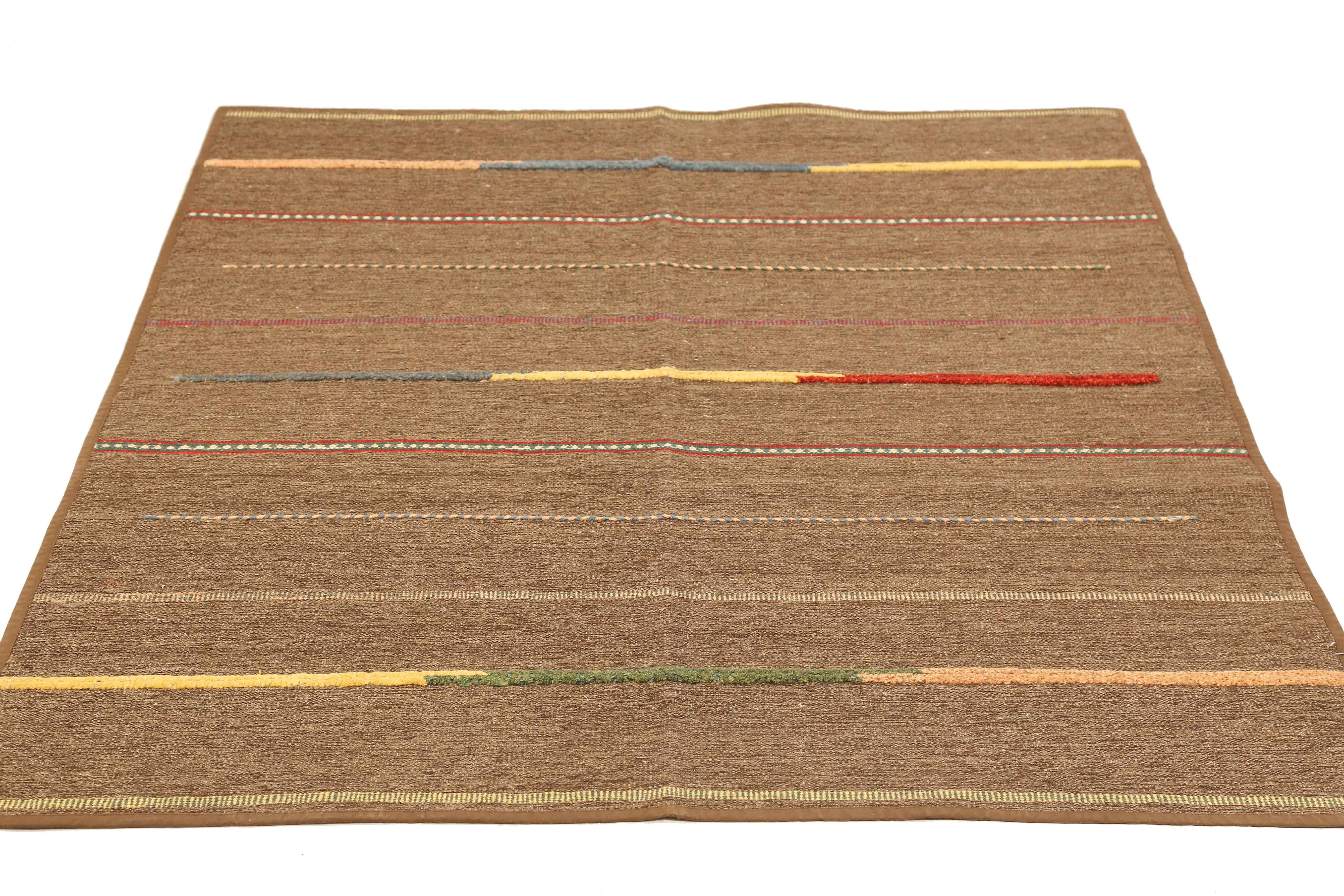 Modern Turkish rug handwoven from the finest sheep’s wool and colored with all-natural vegetable dyes that are safe for humans and pets. It’s a traditional Patch Kilim flat-weave design featuring colored stripes on a brown field. It’s a stunning