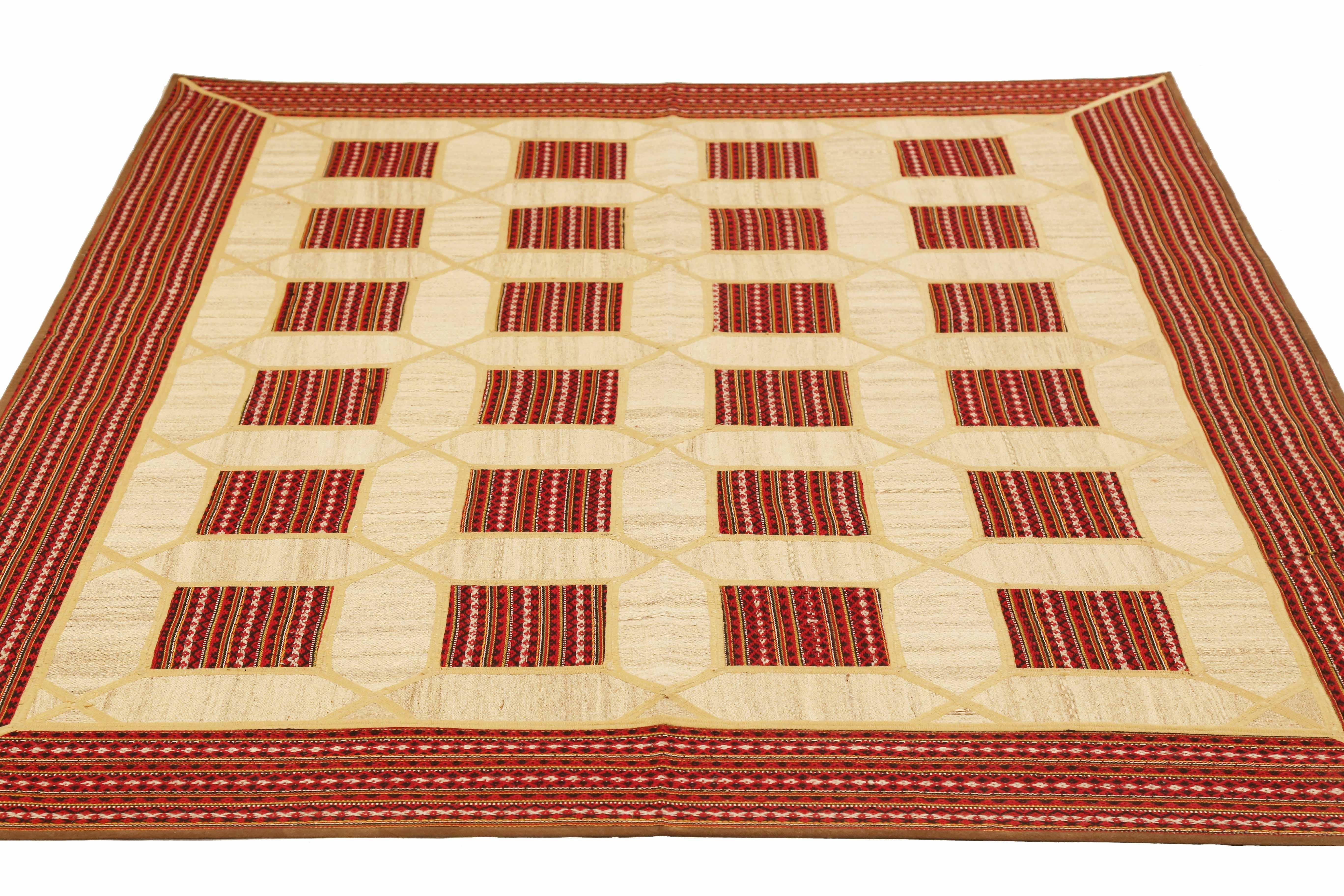 Modern Turkish rug handwoven from the finest sheep’s wool and colored with all-natural vegetable dyes that are safe for humans and pets. It’s a traditional Patch Kilim flat-weave design featuring square patterns in ivory on a red field. It’s a