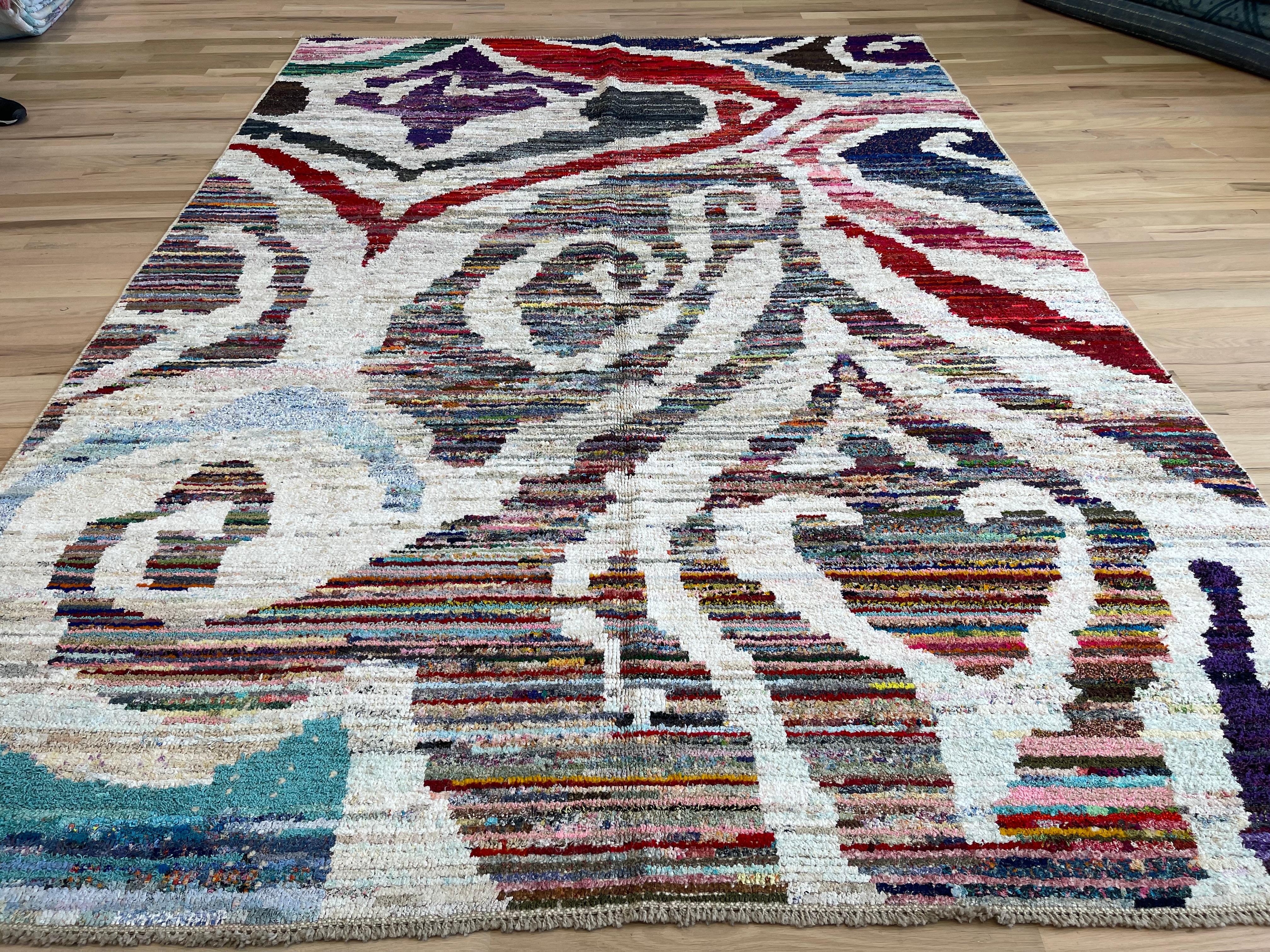 Transform your space with our exquisite Turkish rug in stunning shades of blue, red, and purple. Made from all wool, this bold and ethnic rug adds a touch of luxury and warmth to any room. Elevate your decor with this unique and vibrant piece!