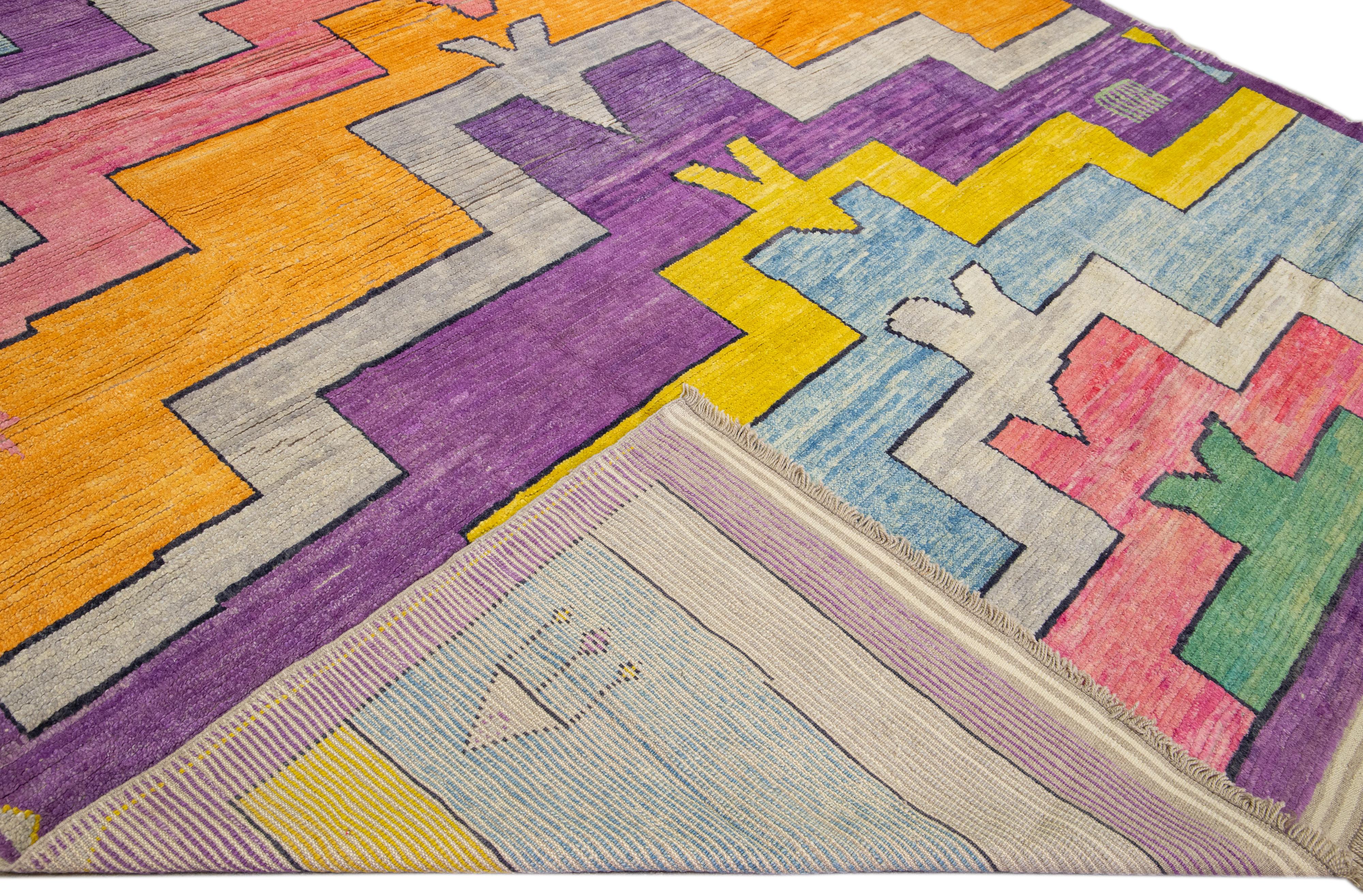 Beautiful modern Art Deco oversize Turkish Tulu hand-knotted wool rug with a geometric abstract design on a multi-color field throughout the piece.

This rug measures 11' x 16'6