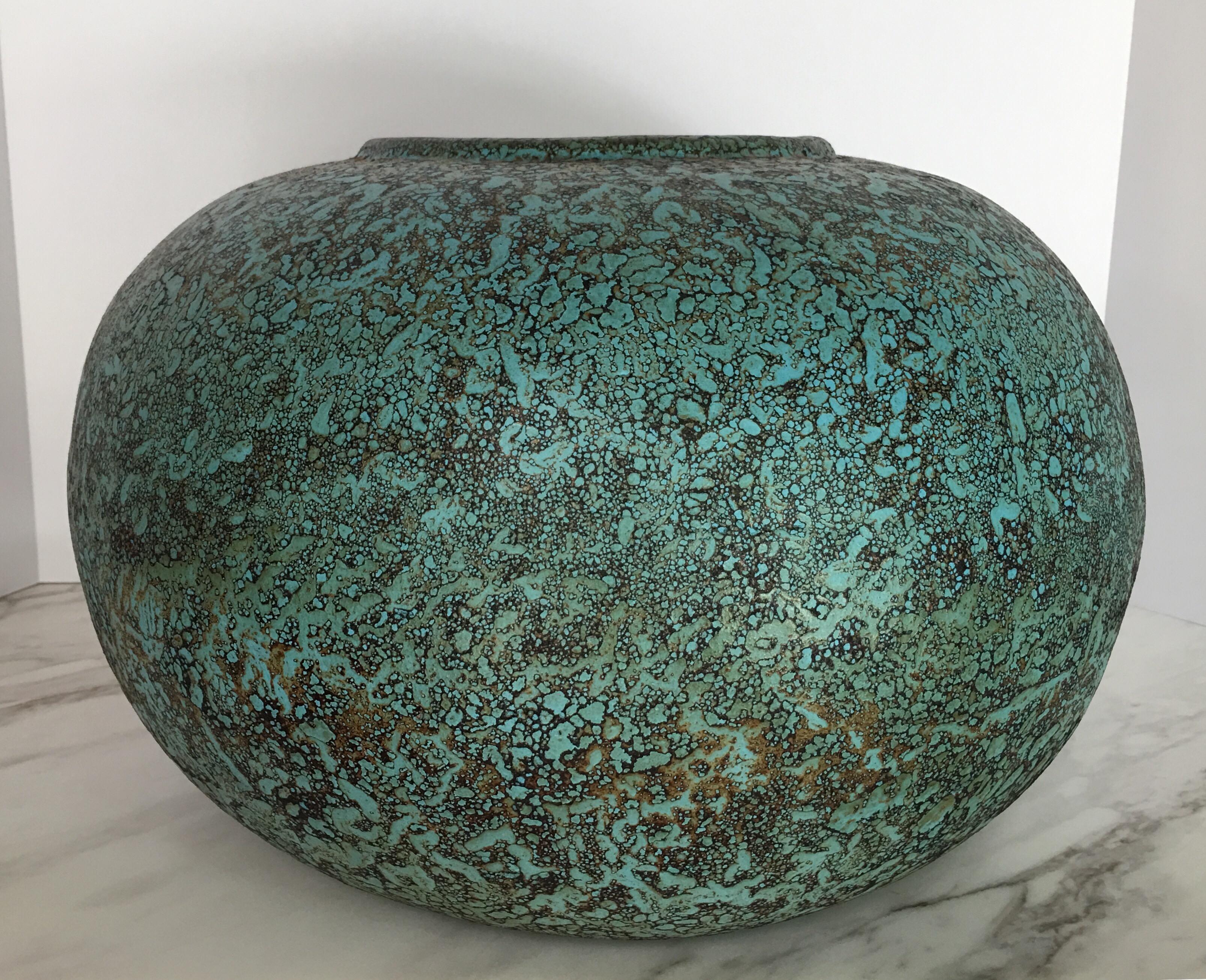 Large round handmade terracotta vase featuring a textural turquoise verdigris-like finish with brown/black burned details. This large scale sculptural centerpiece vase or bowl is truly a statement accessory.