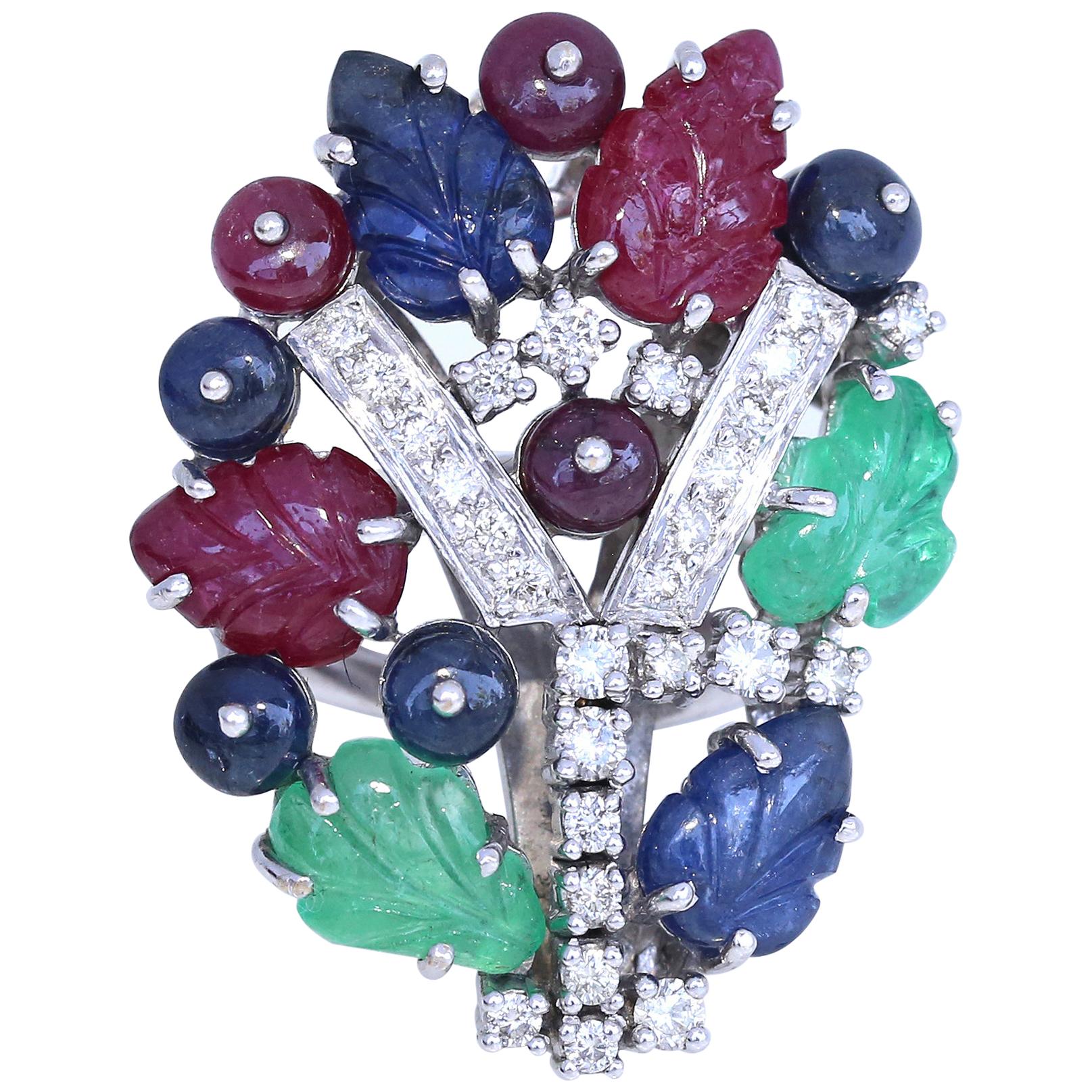 The Tutti Frutti Cocktail Ring. A delicious combination of fine carved Emerald, Ruby, Sapphire and Diamonds give this floral, clover flower an awesome allure. 1980. 
Practical enough for a daytime accessory yet dynamic enough for evening wear,