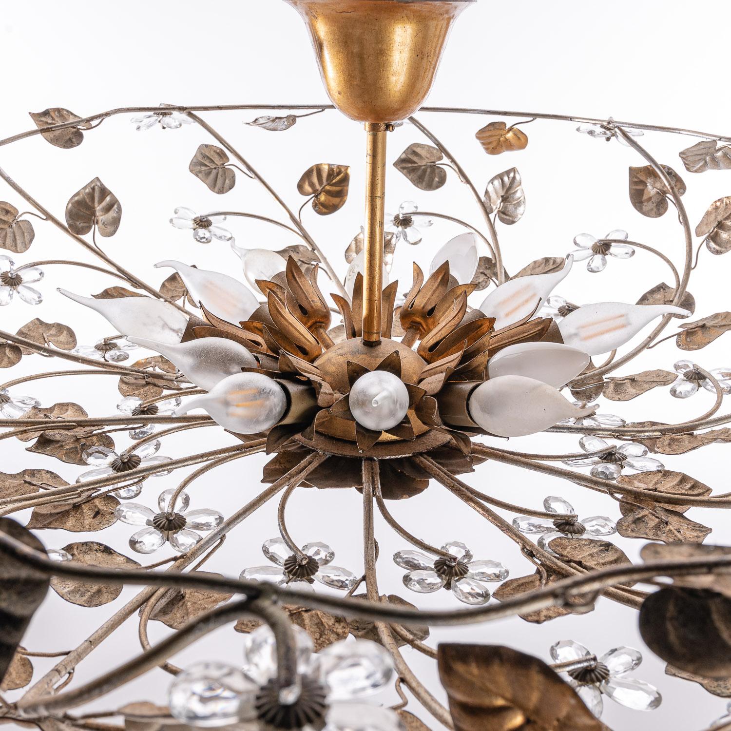 A very large floral flush mount, nicely crafted brass & metal frame decorated with antique silver & gold leaf details. The center piece with brass petals holds twelve E14 sockets. 
Please note, we have 5 smaller flush mounts of the same style. The