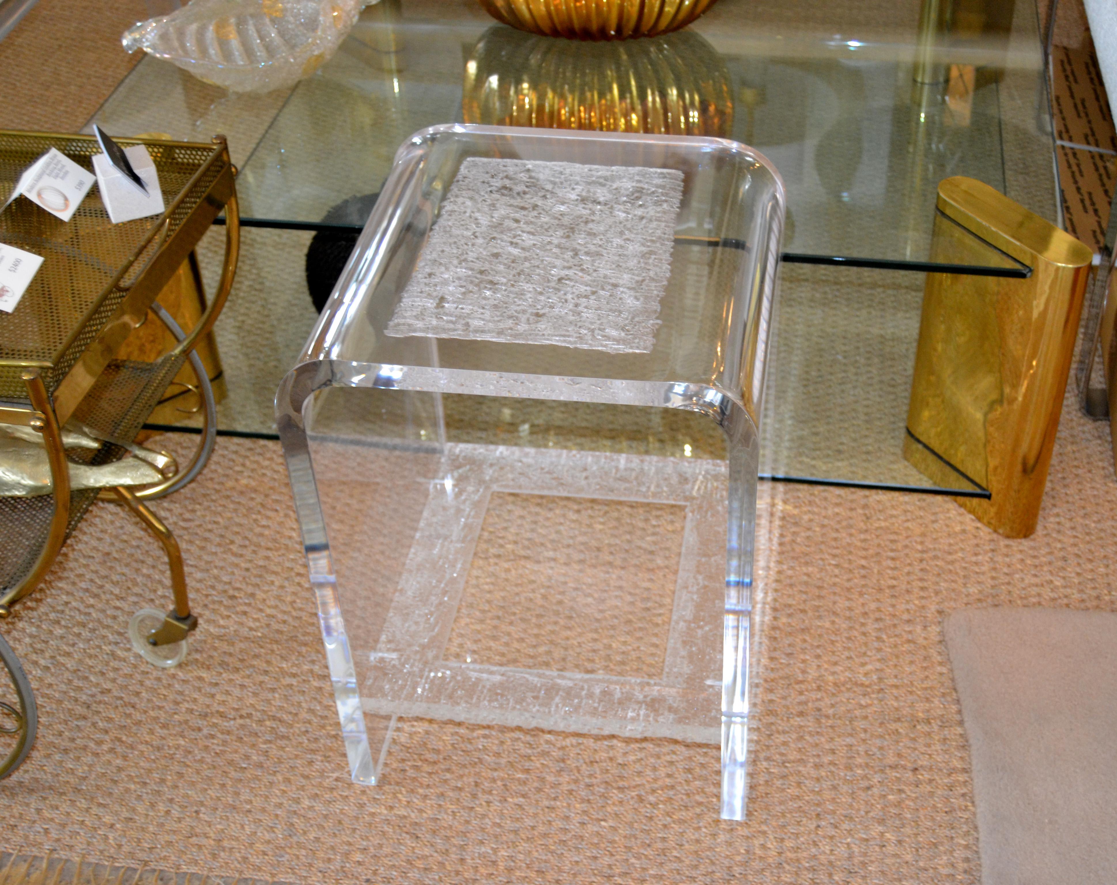 Modern one inch thick two-tier clear Acrylic side table or end table.
The top and base are having chiseled details that appear like crystallized, stunner done.
Sturdy and heavy craftsmanship in clean design.
