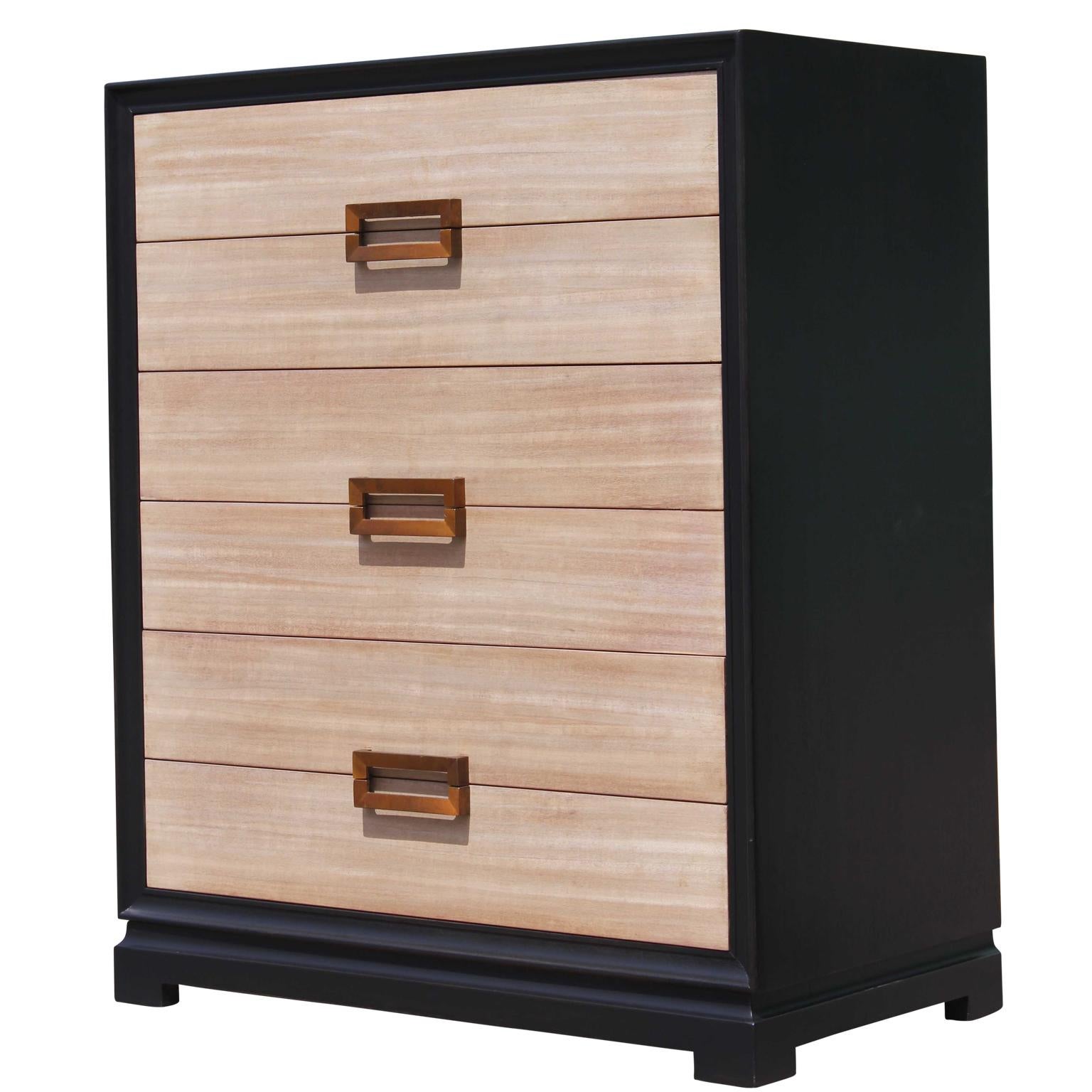 Modern two-tone six-drawer chest of drawers with a neutral finish on the front of the drawers with brass pulls. In the style of Grosfeld House or Dunbar.