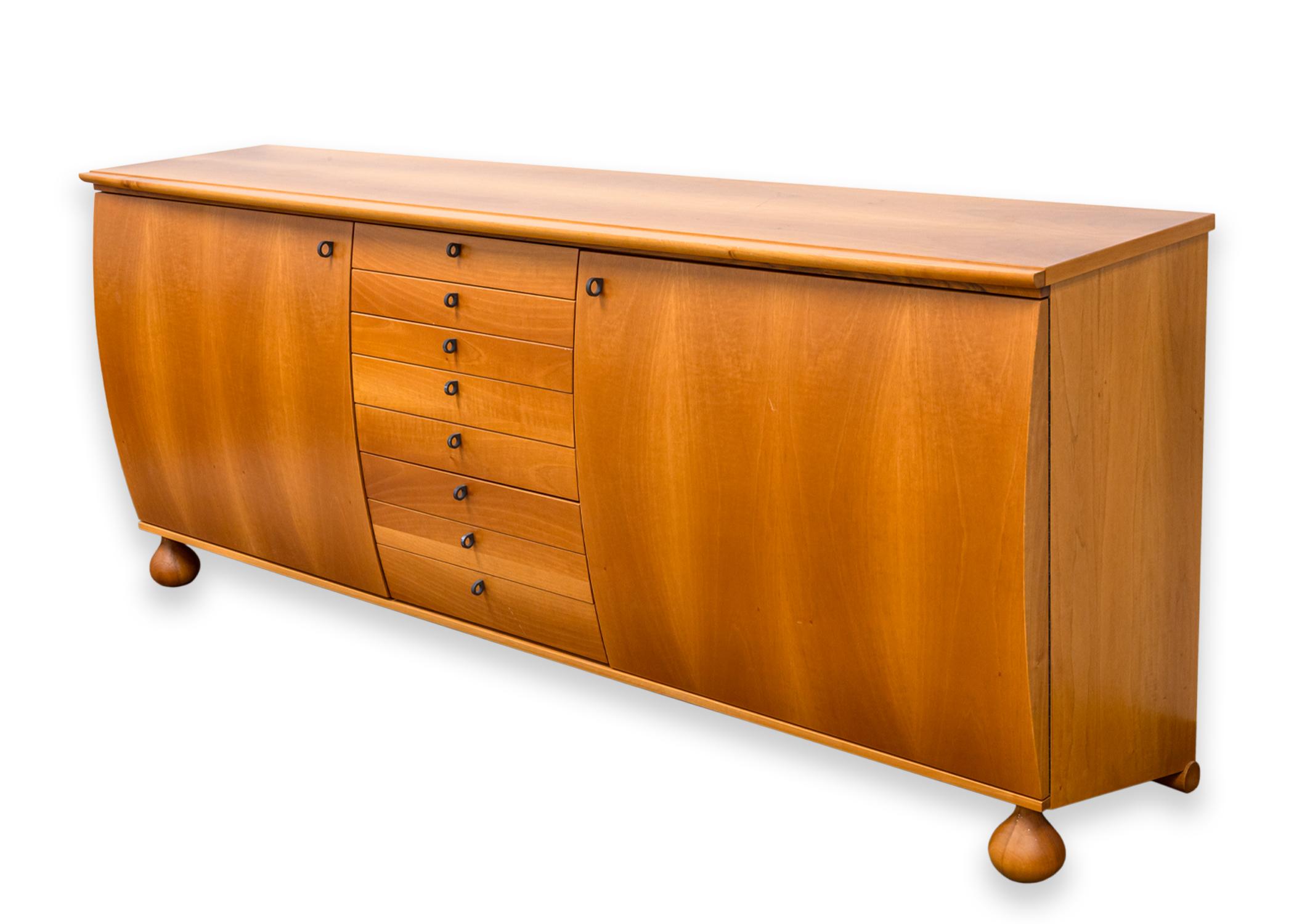 A Giorgetti 1980s wood credenza dresser. A beautiful, unique storage piece designed by Umberto Asnago for Giorgetti Italy. This super cool piece features a light wood construction with gorgeous wood grain, and round metal pull handles. This piece