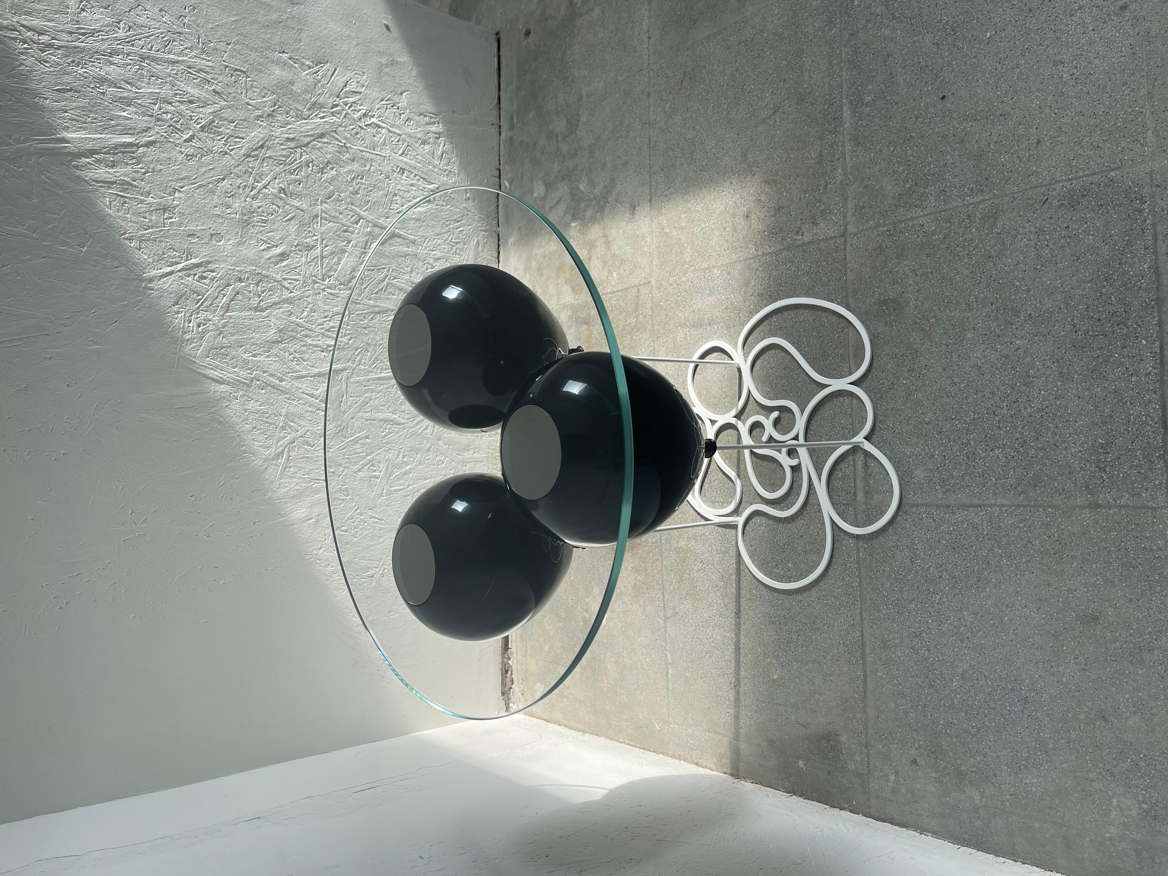 A modern side table with a much darker side from acclaimed British furniture designer Duffy London.

The UP! Balloon Side Table is a playful trompe l’oeil furniture piece.  A trio of metallic, black balloons impresses the illusion of a levitating