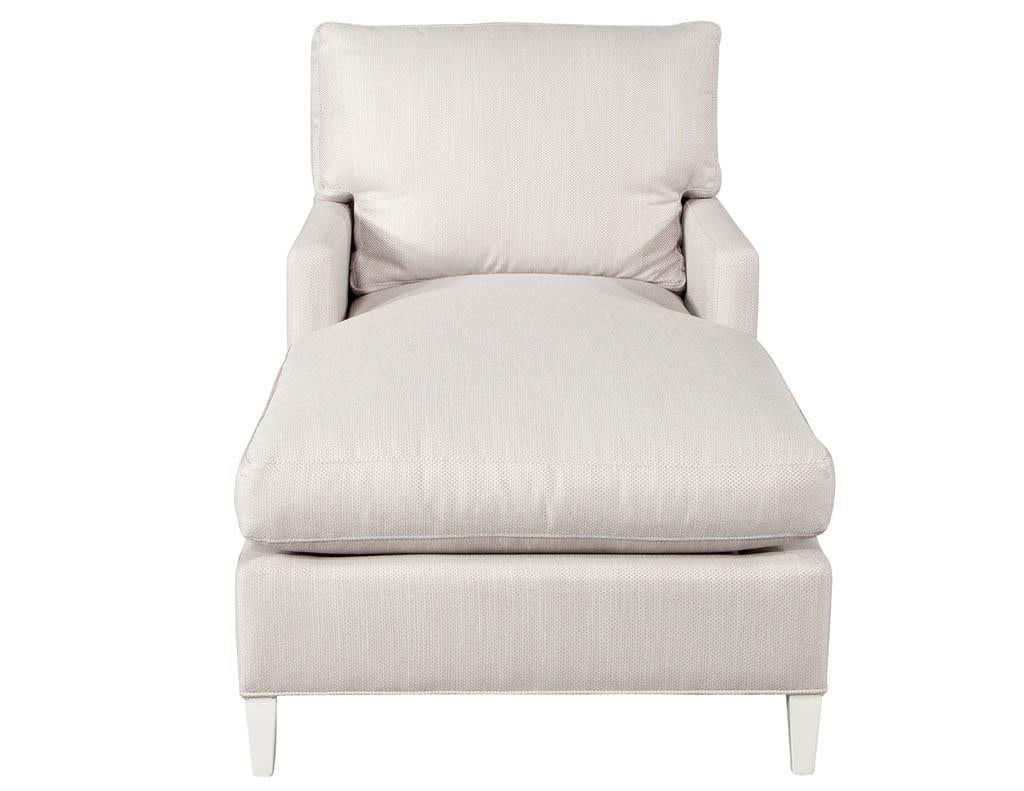 Modern upholstered chaise lounge. Modern clean lined and elegant chaise lounge. Newly upholstered in a designer fabric with satin white finished legs. Seat depth 49