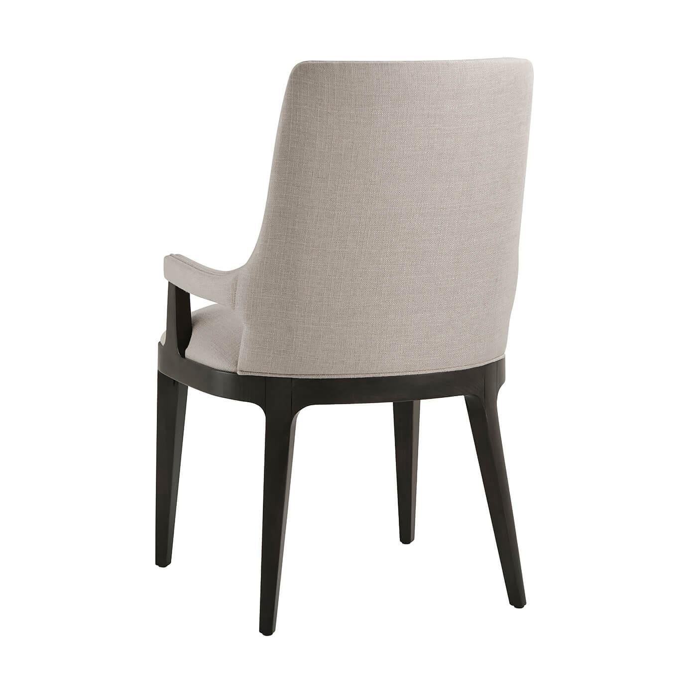 Modern upholstered dining armchair with solid beech and a dark Macadamia finish. With a scoop barrel back and tightly upholstered seat cushion, upholstered arms on clamped tapering legs.

Dimensions:
20.25