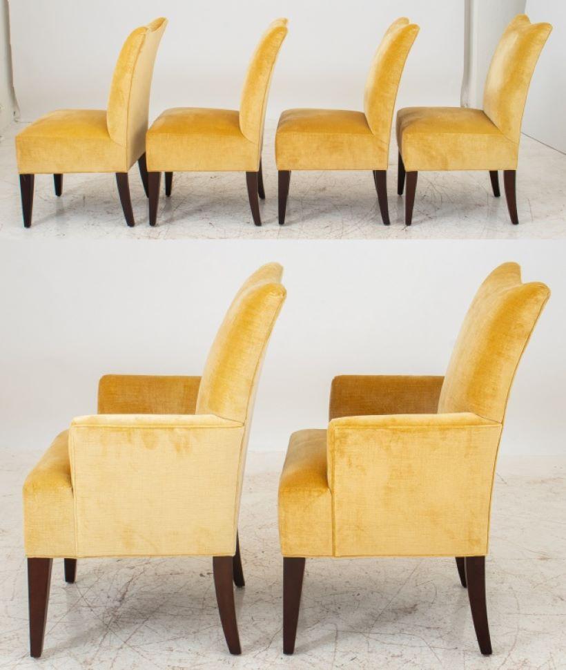 Modern upholstered dining chairs, two arms and four sides, with upholstered scoop backs and seats now covered in a pale gold velvet, on square tapering wooden legs. Measures: 39