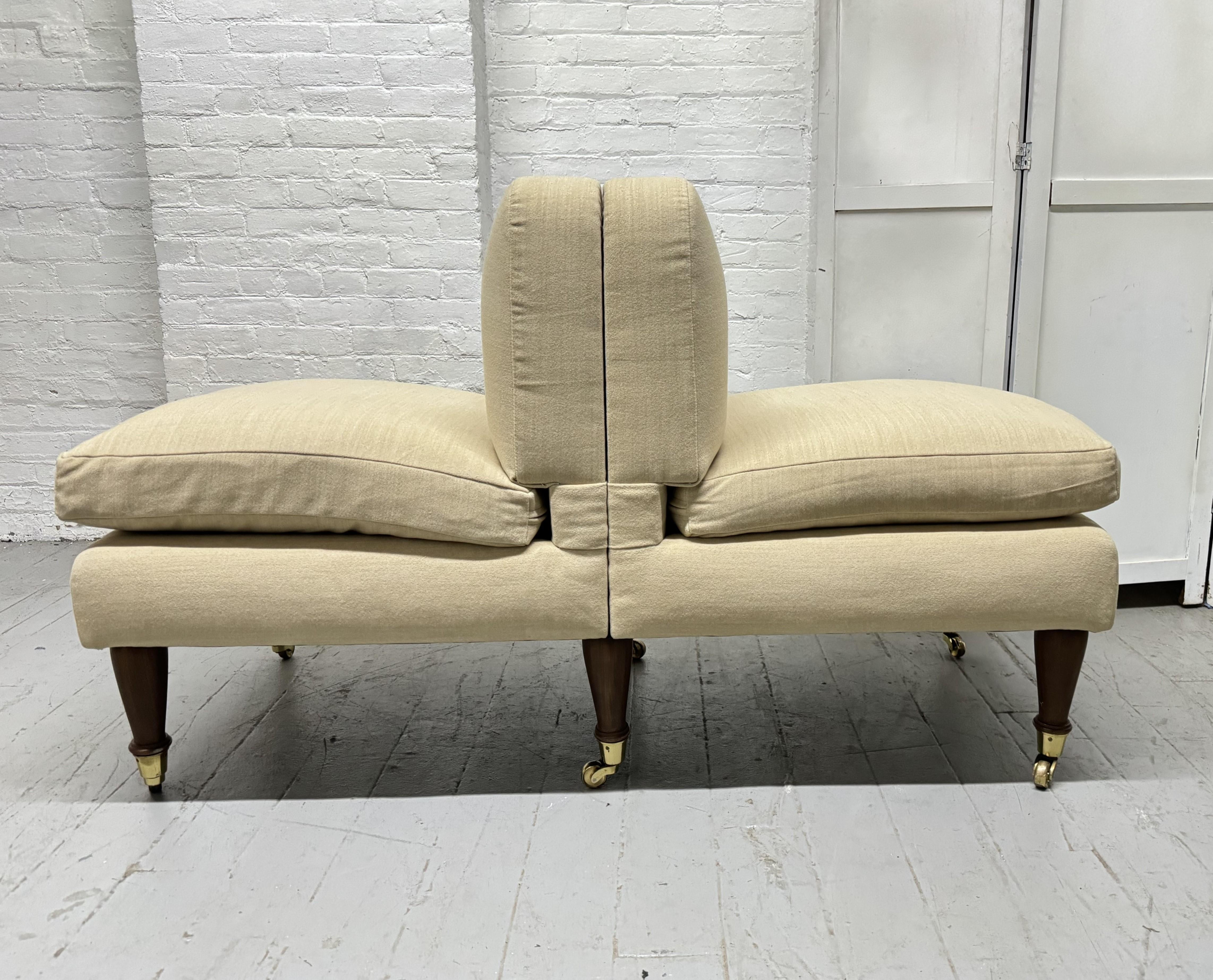 Modern Upholstered Tete-a-Tete. The legs are walnut and newly upholstered.