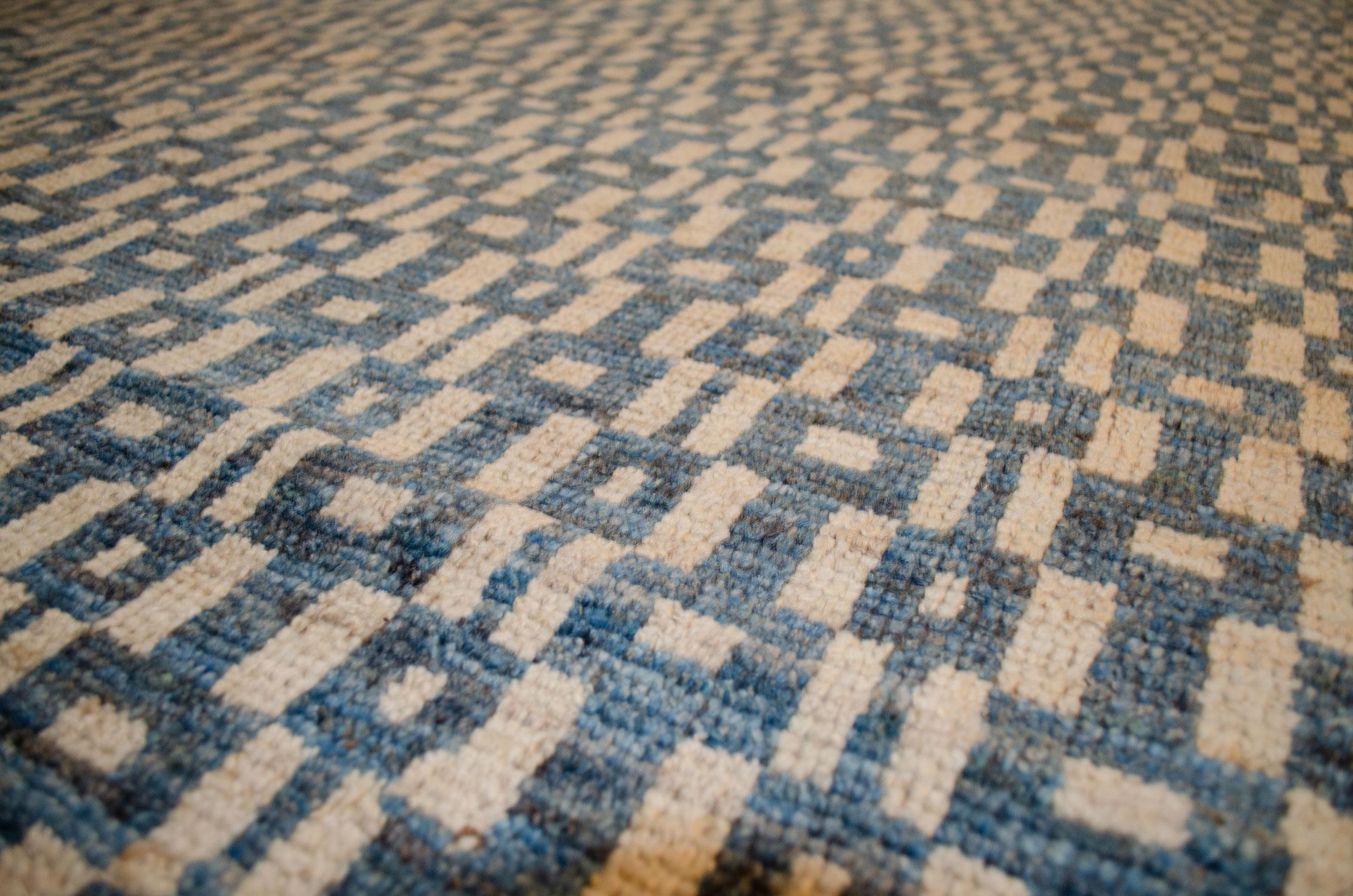 This modern design carpet woven with an Ushak weave is a production piece. The use of high-quality handspun wool and natural dyes has given a feel and look to this rug that will be hard to match anywhere. The subtle changes of colour in the field