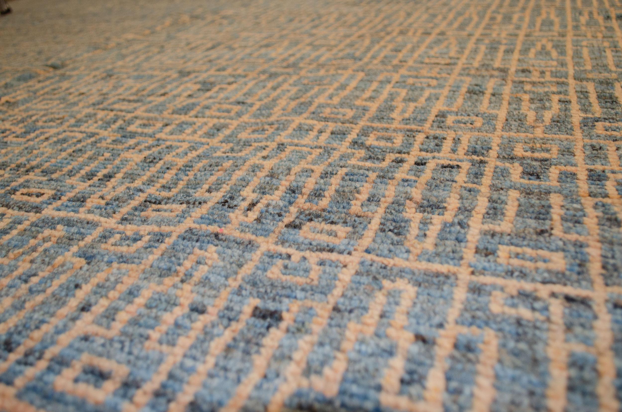 This modern design carpet woven with an Ushak weave is a production piece. The use of high-quality handspun wool and natural dyes has given a feel and look to this rug that will be hard to match anywhere. The subtle changes of colour in the field