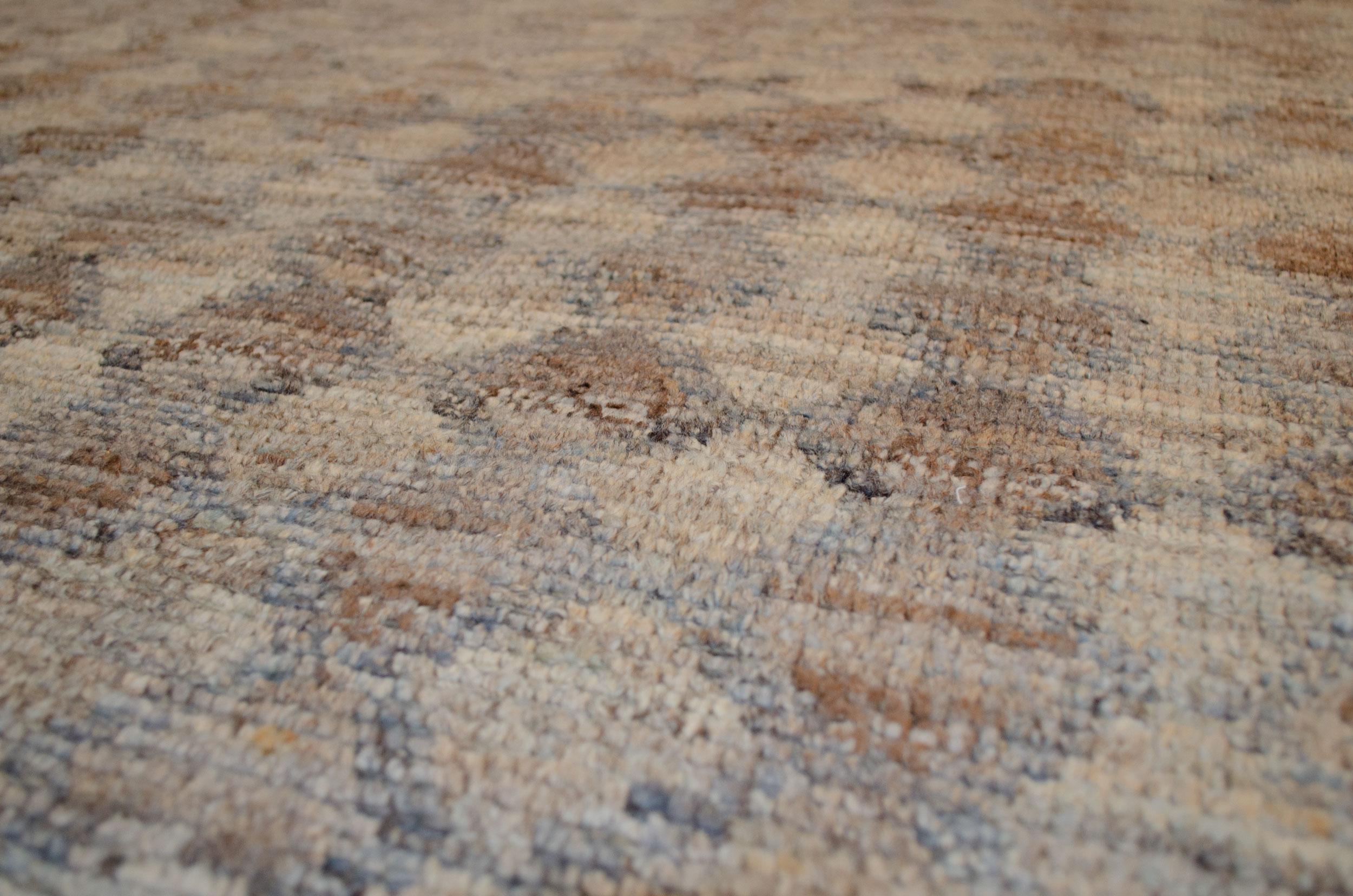 This modern design carpet woven with an Ushak weave a production piece. The use of high-quality handspun wool and natural dyes has given a feel and look to this rug that will be hard to match anywhere. The subtle changes of colour in the field