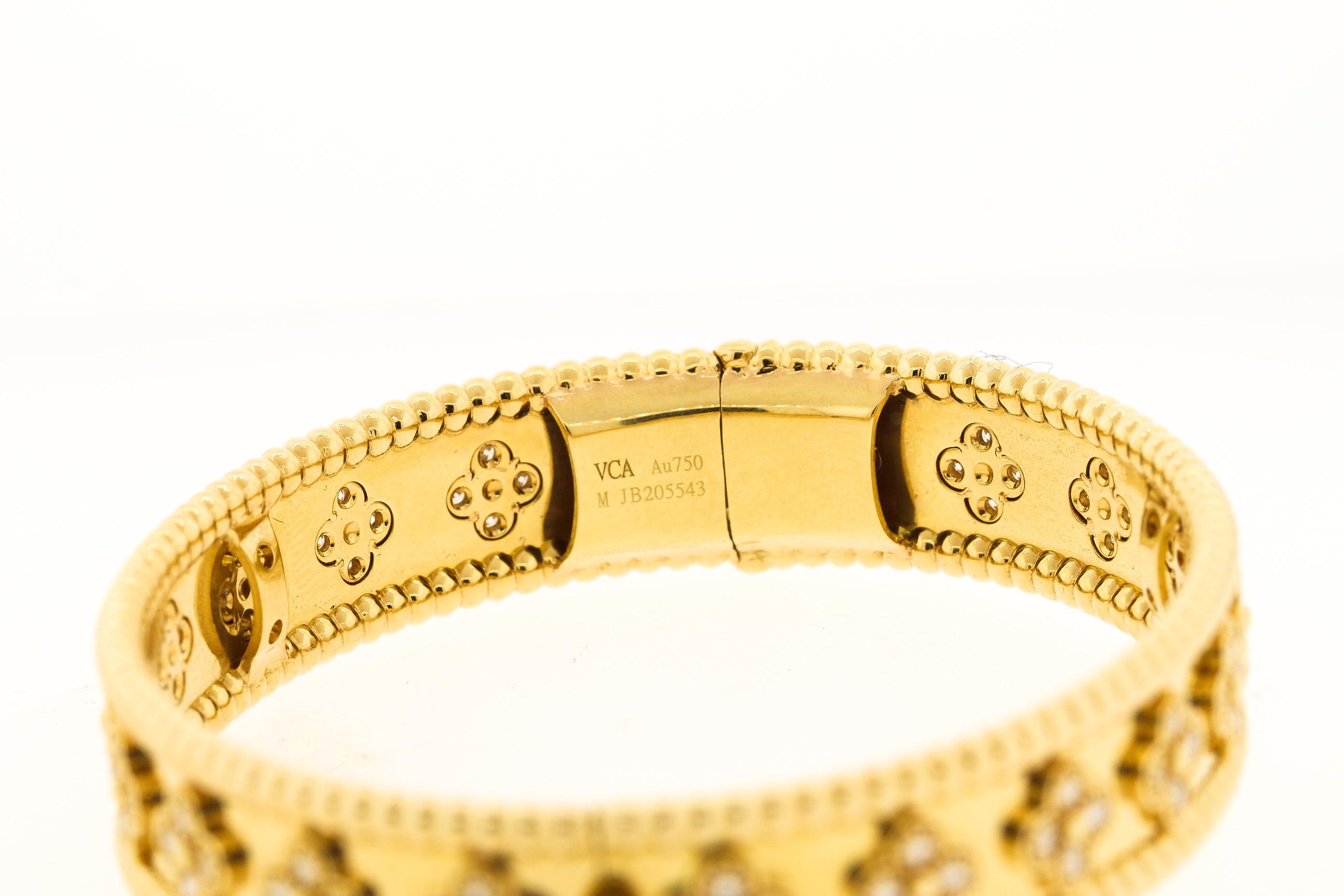 A modern 18k yellow gold and diamond bracelet by Van Cleef & Arpels from the Perlée collection. The diamonds are clustered in a clover motif throughout the bangle. The clovers are set with an estimated 1.75 carats of diamonds. They are VCA quality