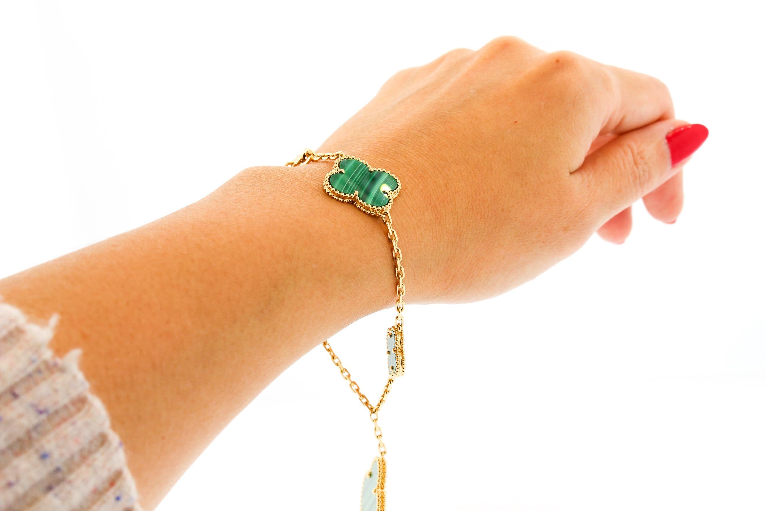 Colorful Malachite Magic Alhambra 5 Motif bracelet by Van Cleef & Arpels. With varying sizes and Alhambra flowers hanging off like charms, this bracelet is fun and whimsical. The green is an eye catching color. The bracelet is 7.5 inches long. It is