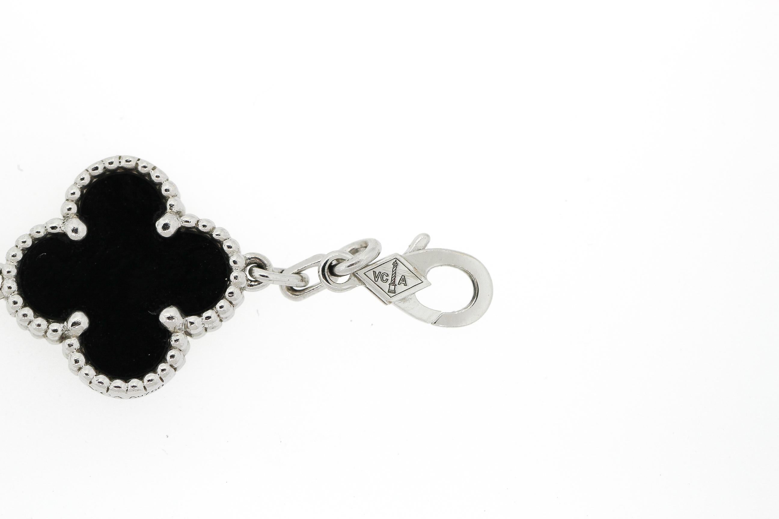 A modern black onyx and diamond 5 motif Alhambra bracelet by Van Cleef & Arpels. The bracelet is made in 18k white gold and set with white diamonds that are D to F color and VS clarity. There are 24 stones that weigh 0.96 carats. There are three