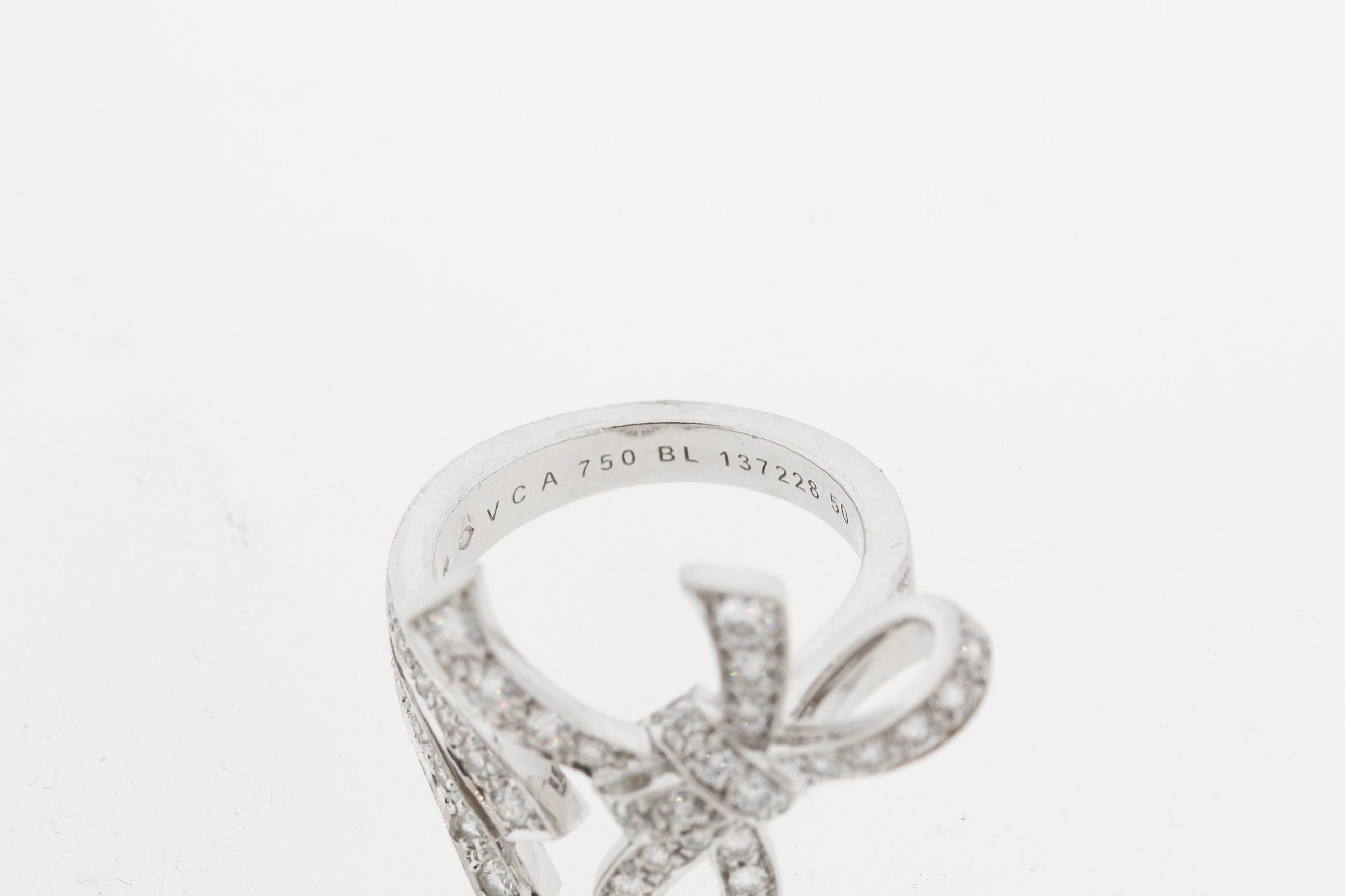 A feminine white gold diamond “ribbon” style ring by Van Cleef & Arpels circa 1990. The ring is set with 45 round brilliant diamonds weighing approximately 1.05 carats. They are E to F color and VS clarity. The ring has very nice dimension with a