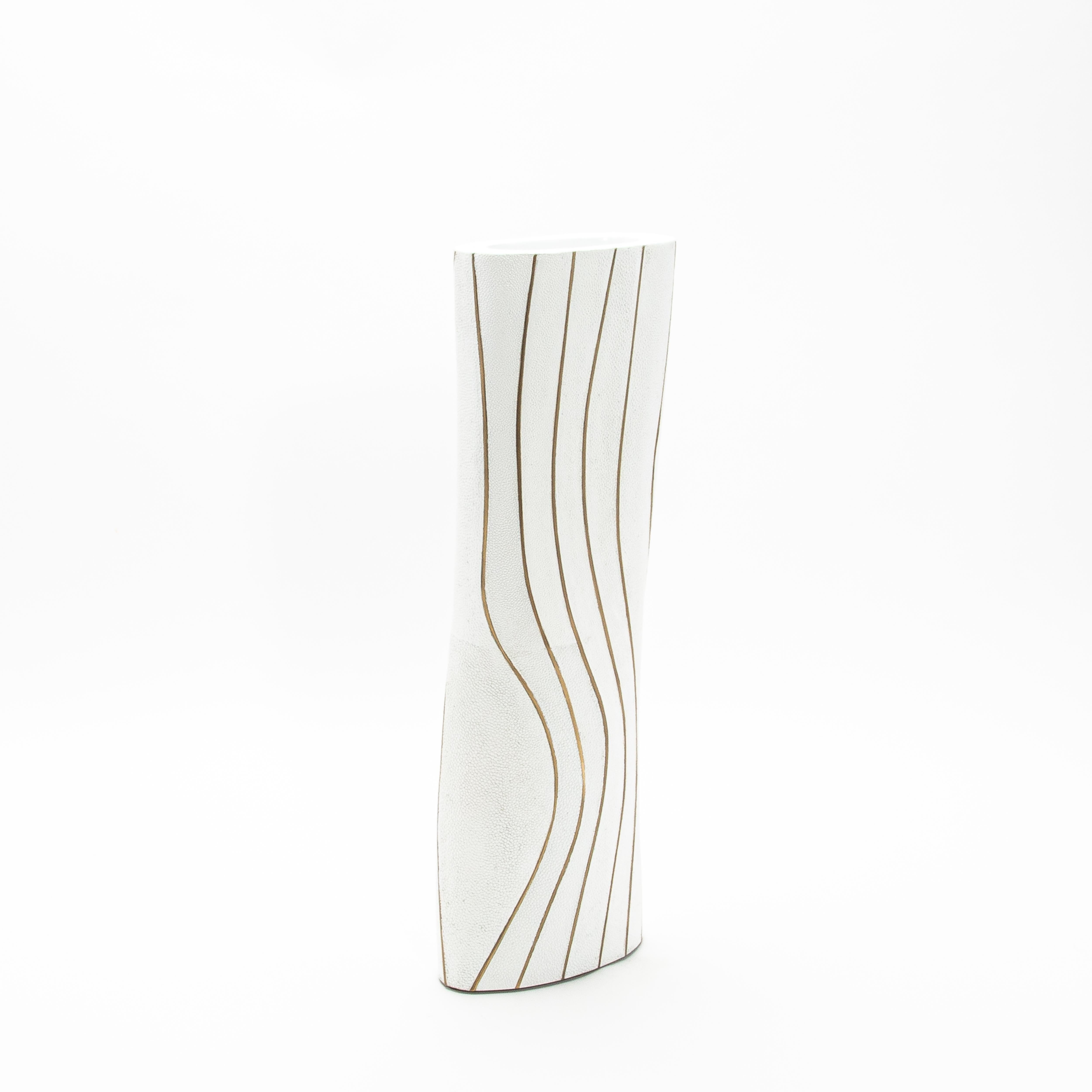 The Storm Vase by Kifu Paris is a true masterpiece of modern design, embodying luxury and sophistication through its impeccable craftsmanship. This vase, sculpted with flowing curves, is meticulously hand-crafted in delicate shagreen, its textured