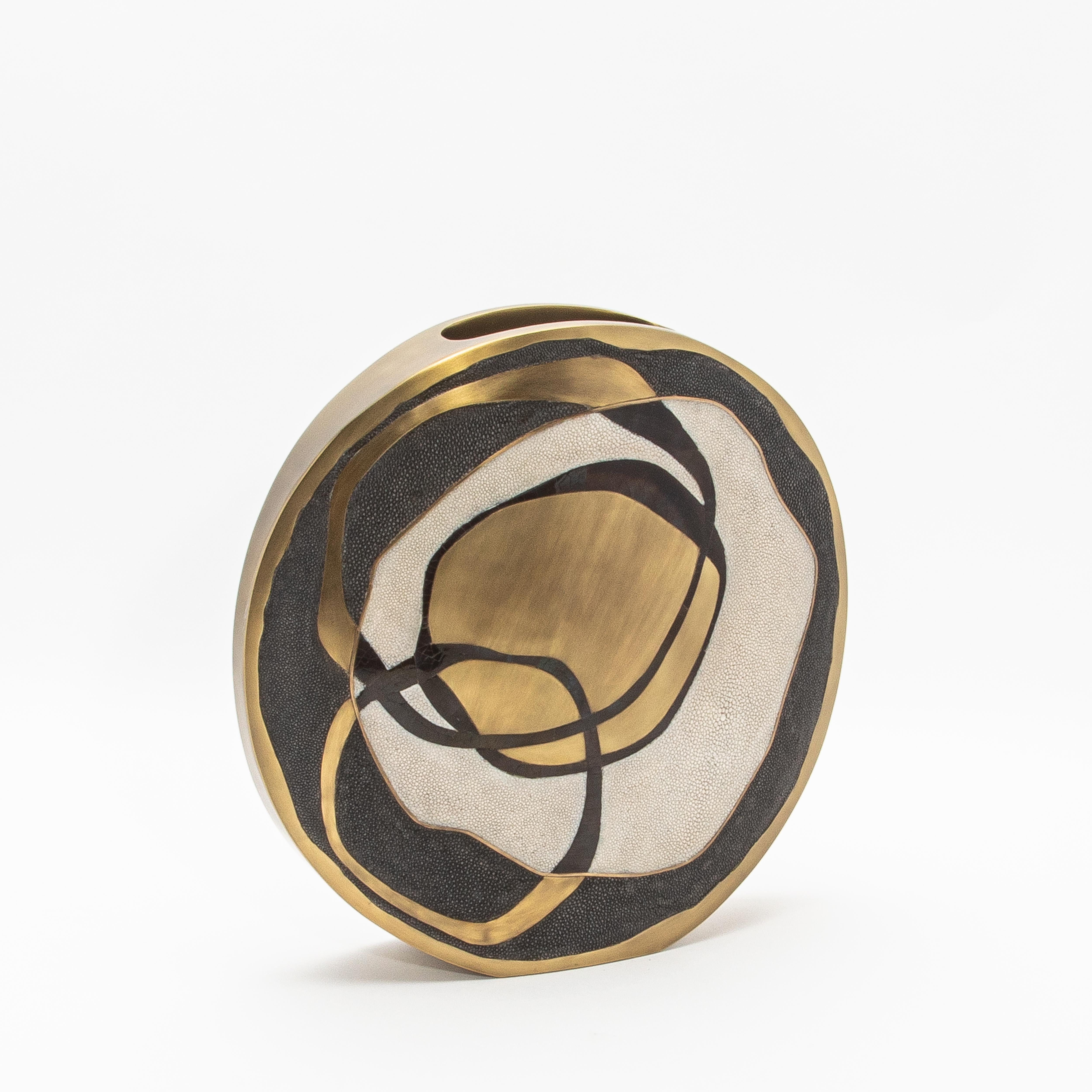 The Rose Vase by R&Y Augousti is a stunning creation that embodies contemporary luxury through its masterful combination of exquisite materials. Handcrafted from rich shagreen, bronze patina brass, and intricate pen shell, this vase is a testament